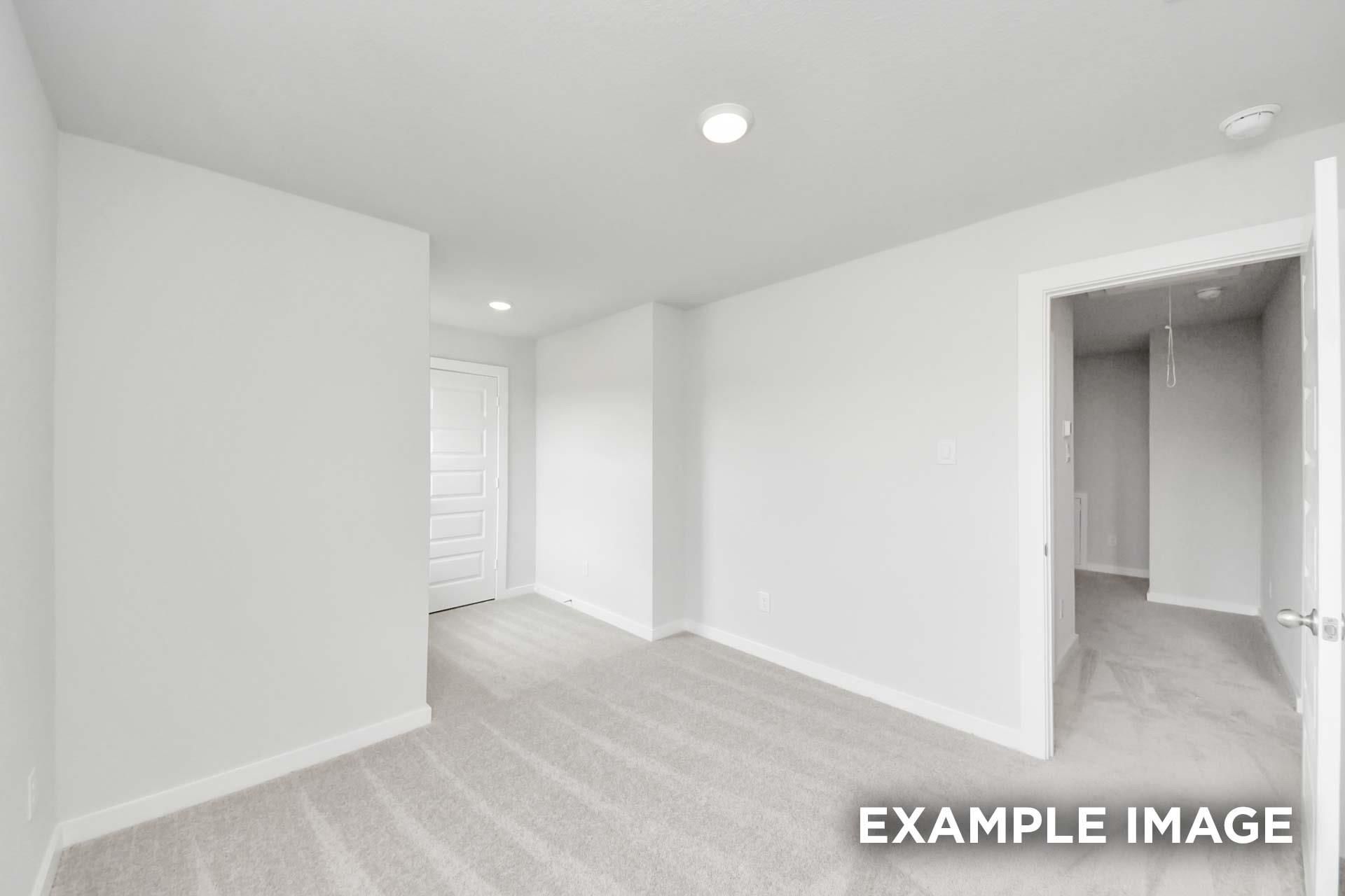 Bright empty bedroom with plush carpet, white walls, and walk-in closet in Davidson Homes The Blanco E, Windmill Estates, Magnolia