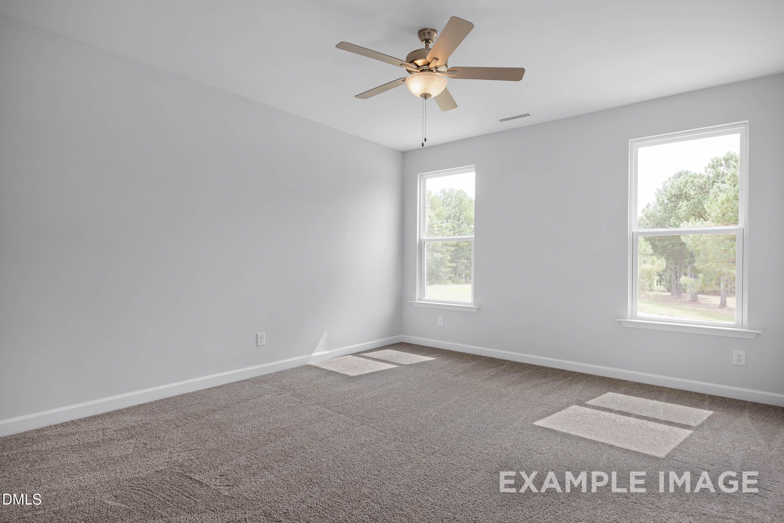 Bright bedroom with ceiling fan, beige carpet, and double windows in The Ash B floor plan, Davidson Homes, Lillington, NC