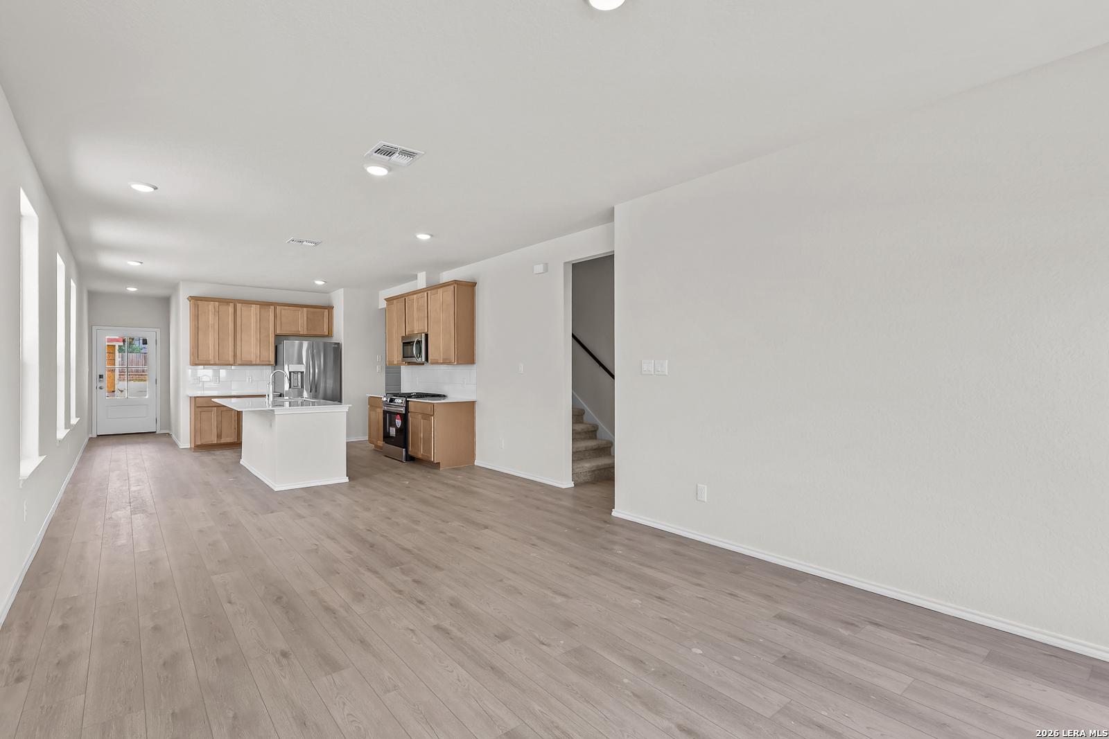 Open-concept kitchen and living area in The Gillian B floor plan by Davidson Homes in Meadows at Oak Creek, San Antonio.