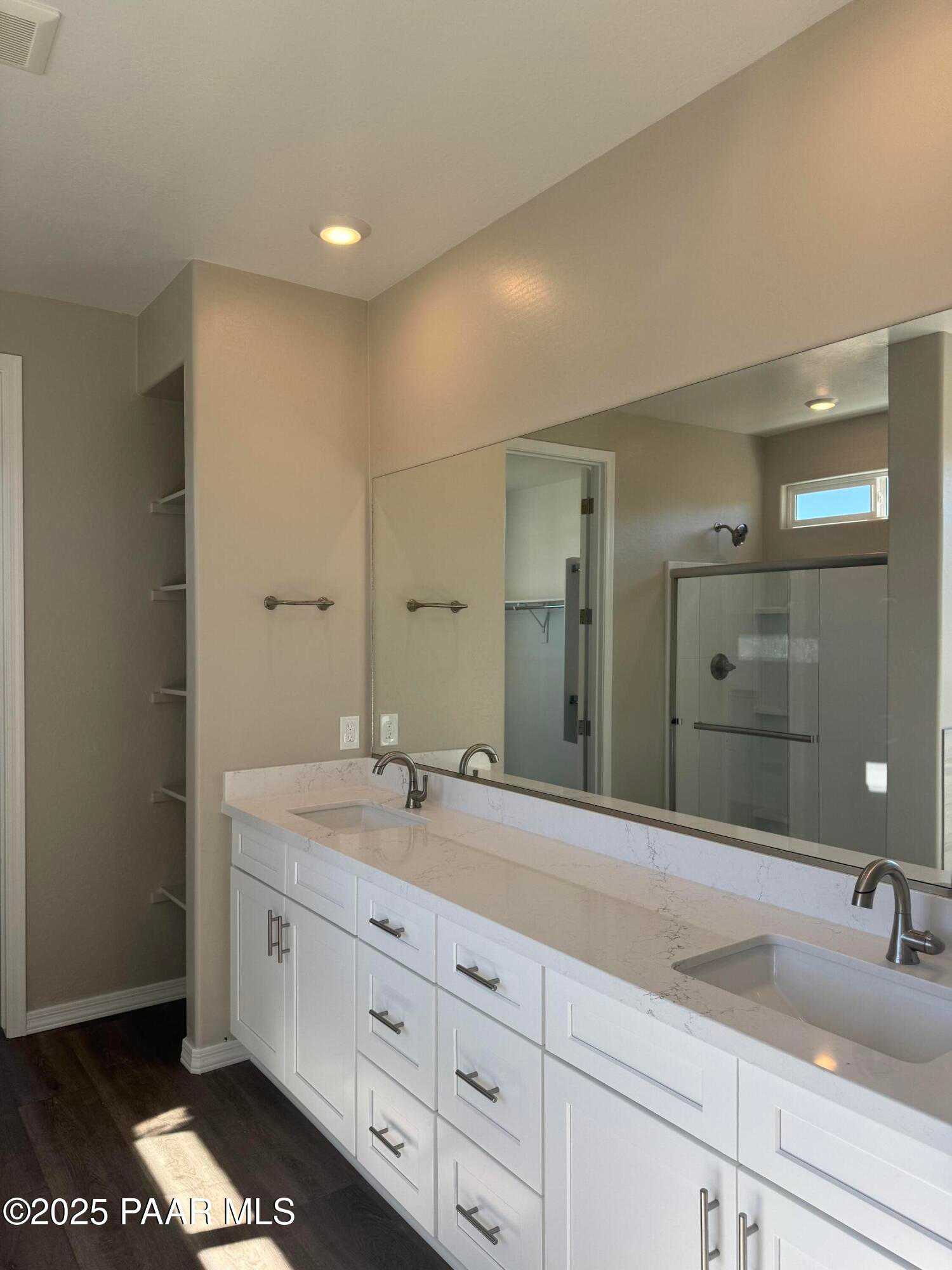 Elegant master bathroom with double quartz vanity, large mirror, and walk-in shower in Davidson Homes The Monarch E, Prescott, AZ