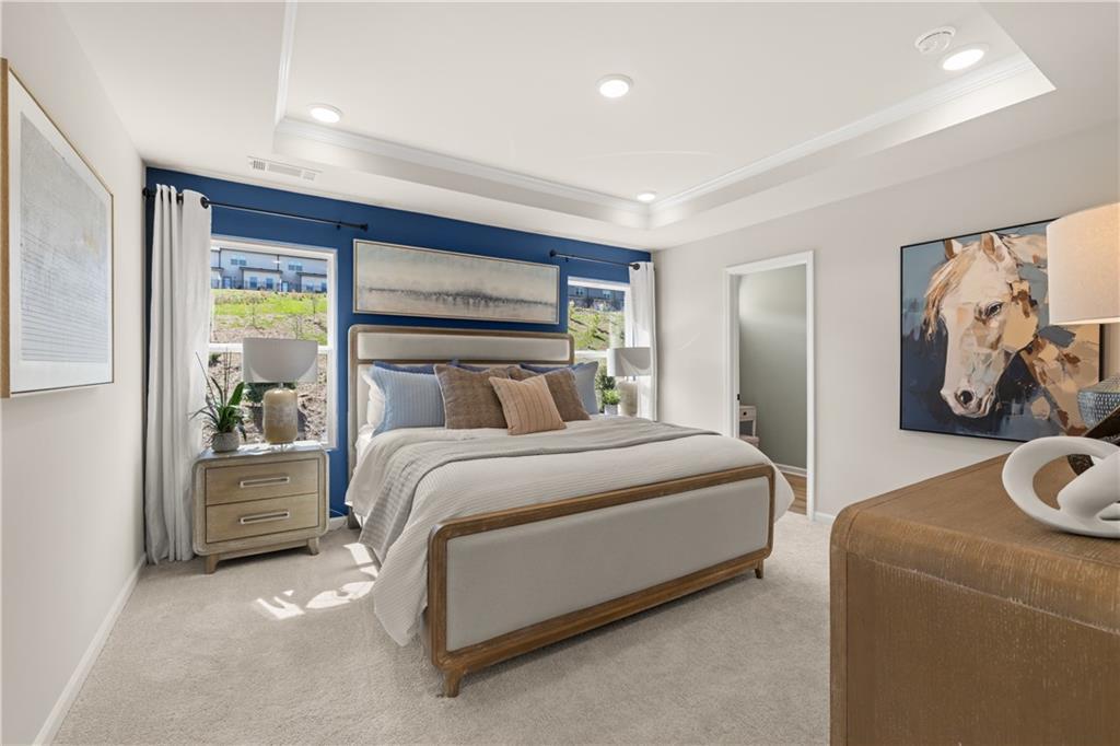 Elegant master bedroom with navy accent wall, king bed, horse artwork, and tray ceiling in Davidson Homes The Burton C, Canton, GA