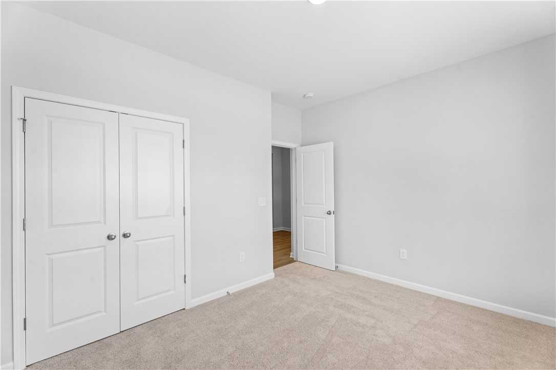 Bright secondary bedroom with double closet doors and bath access in Davidson Homes The Luna B, Opelika, Alabama