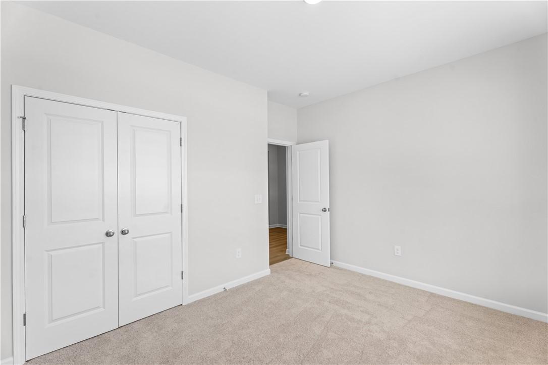 Bright secondary bedroom with double closet doors and bath access in Davidson Homes The Luna B, Opelika, Alabama