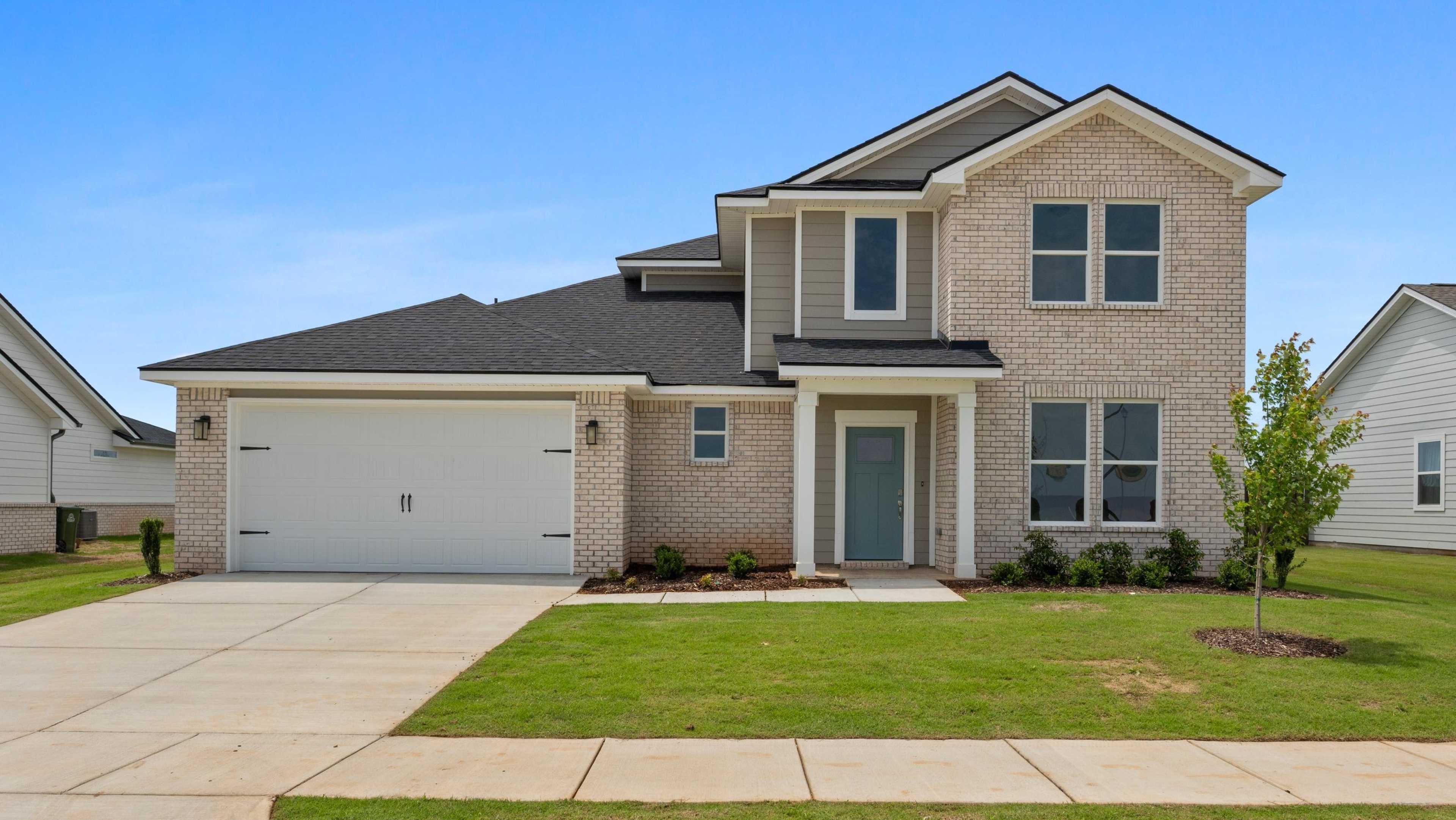Modern two-story brick home at 21971 Huntington Drive open house by Davidson Homes, with garage, driveway, and lush lawn