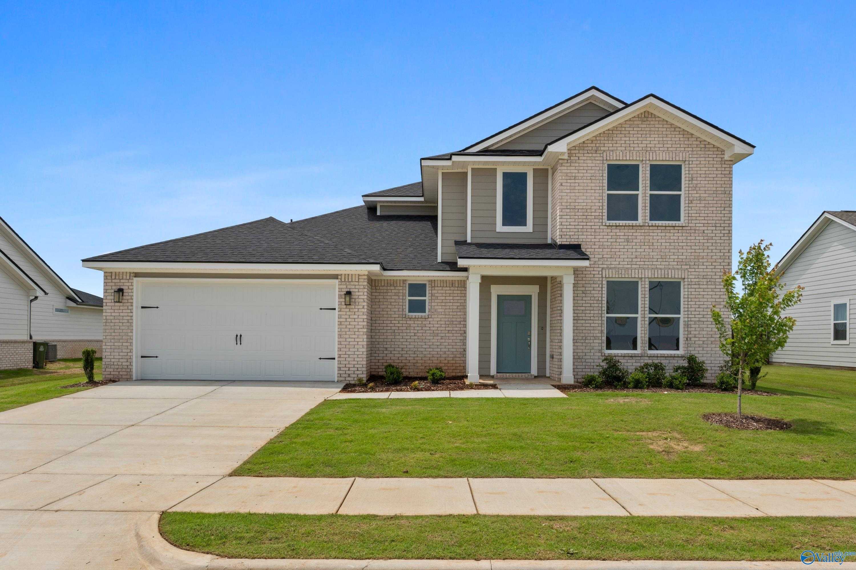 The Dorado 2-story brick home with 2-car garage, driveway, and landscaped yard in Anderson Farm, Athens, Alabama
