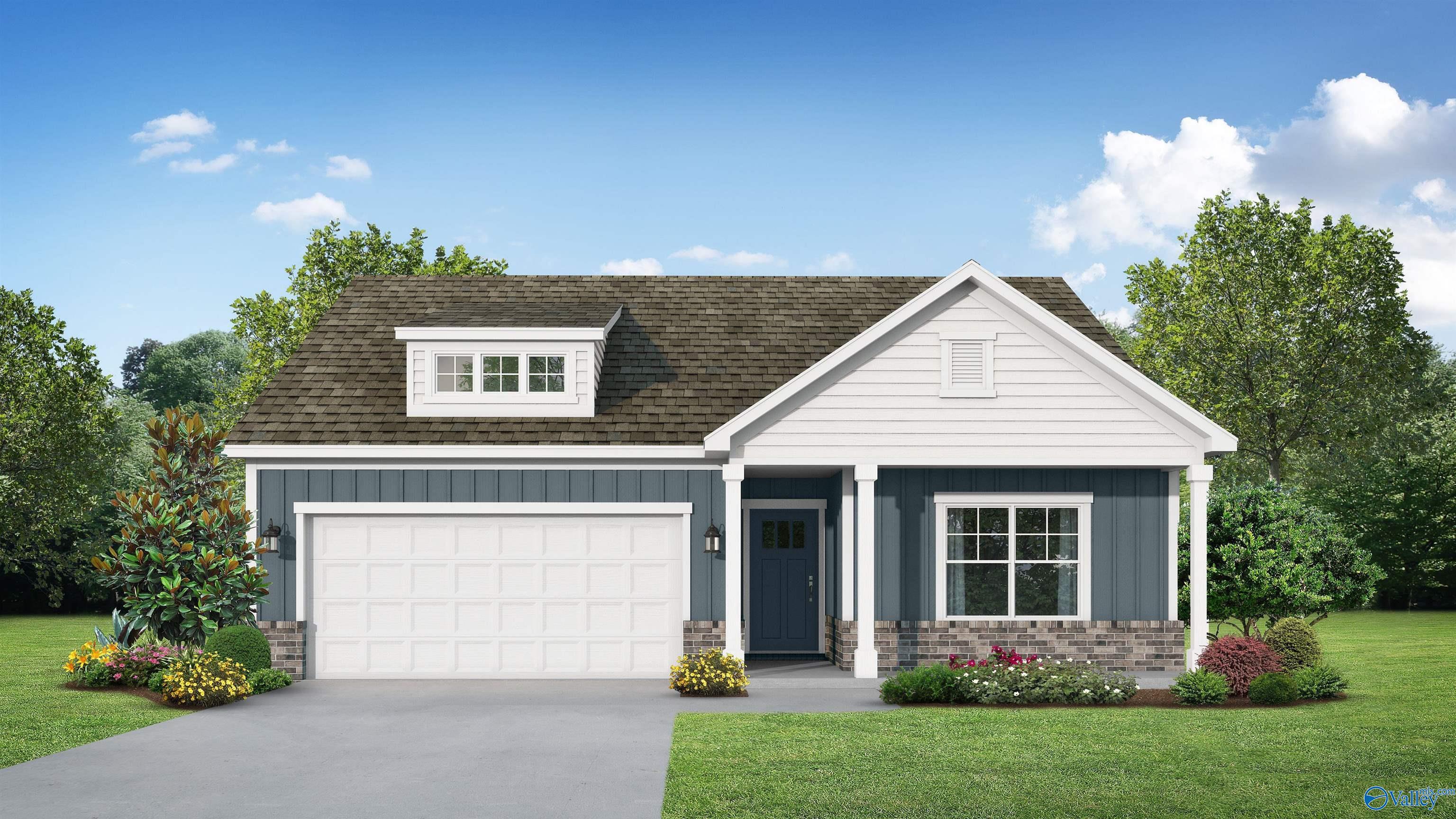 Charming 1-story 3-bedroom Davidson Homes Franklin E with navy siding, 2-car garage, dormer window, and landscaped yard in Noble Ridge, Cullman, Alabama