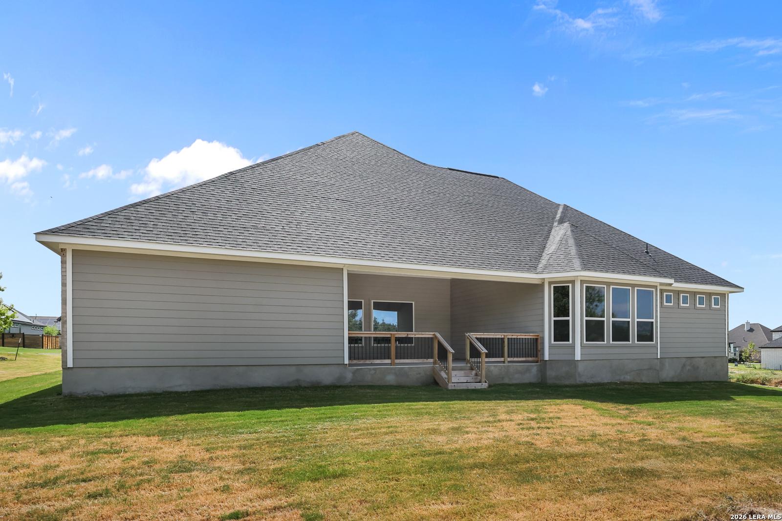 Covered back patio and large backyard of The Summerlin B floor plan by Davidson Homes in Potranco Oaks, Castroville, Texas.