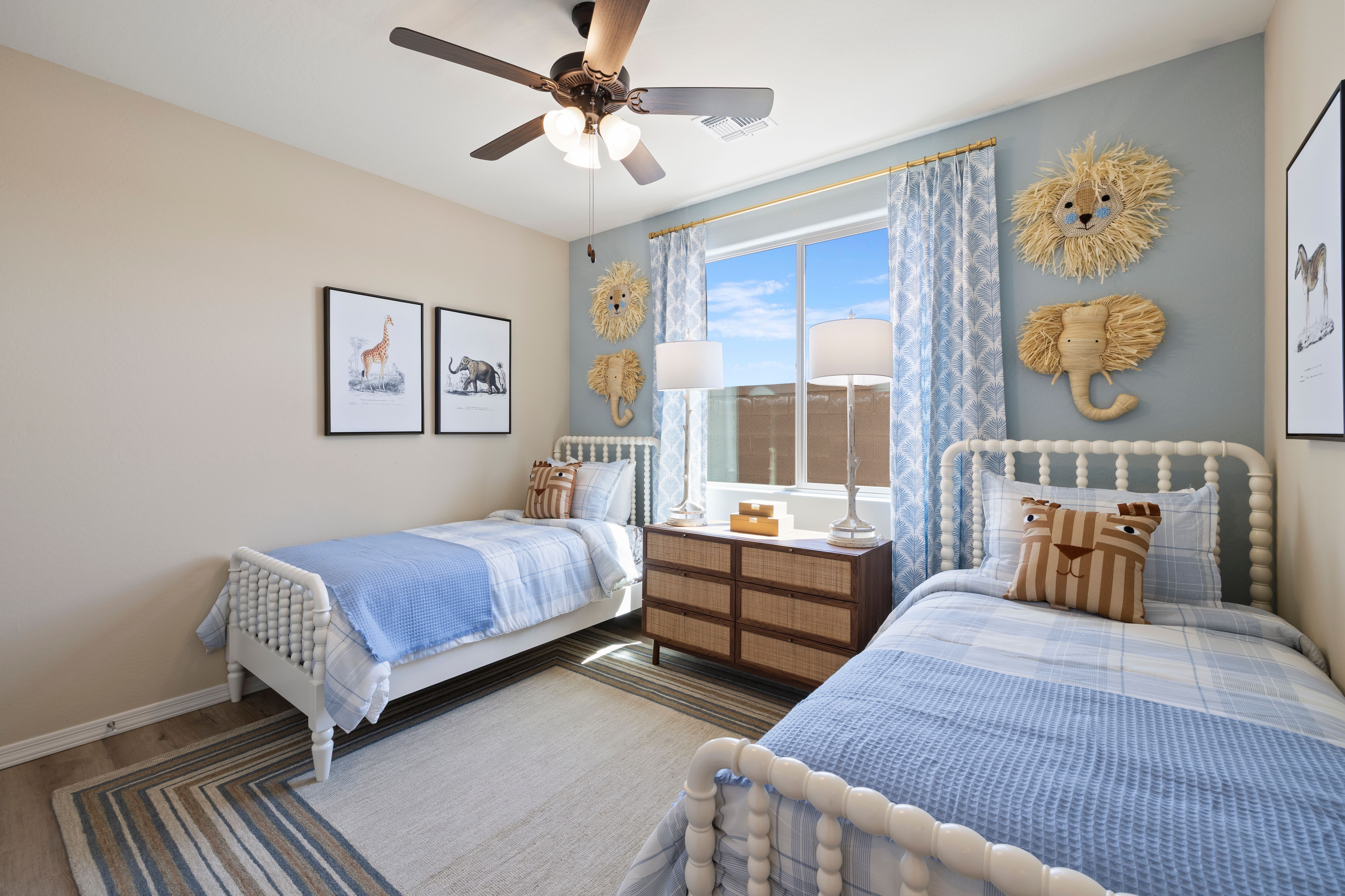 Animal-themed kids' twin bedroom with blue bedding, rattan lion elephant decor at North Ridge Pronghorn Ranch Prescott Valley AZ