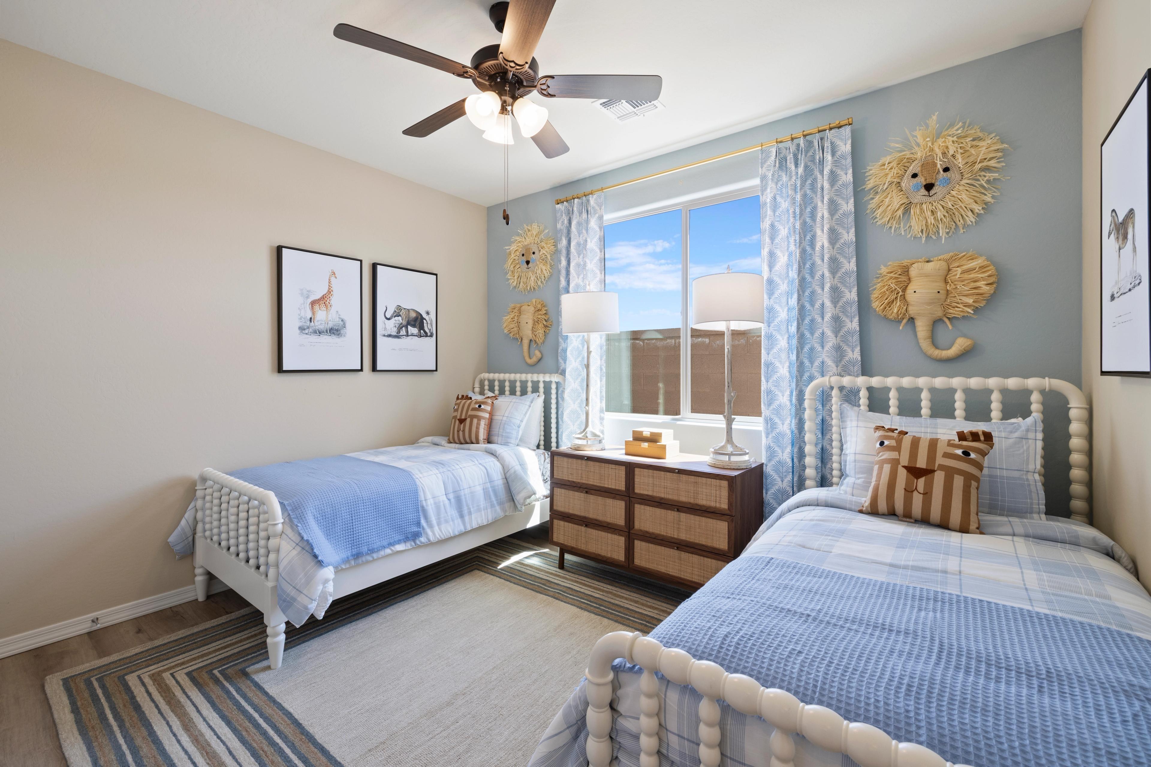 Animal-themed kids' twin bedroom with blue bedding, rattan lion elephant decor at North Ridge Pronghorn Ranch Prescott Valley AZ