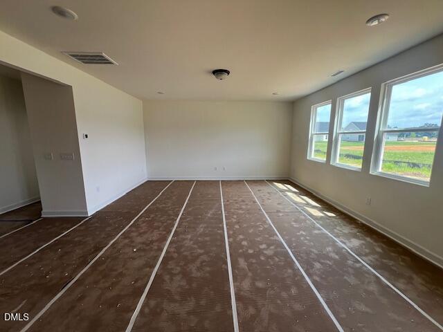 Spacious unfinished living area with large windows in The Hickory II B floor plan at Retreat at North Main in Lillington.