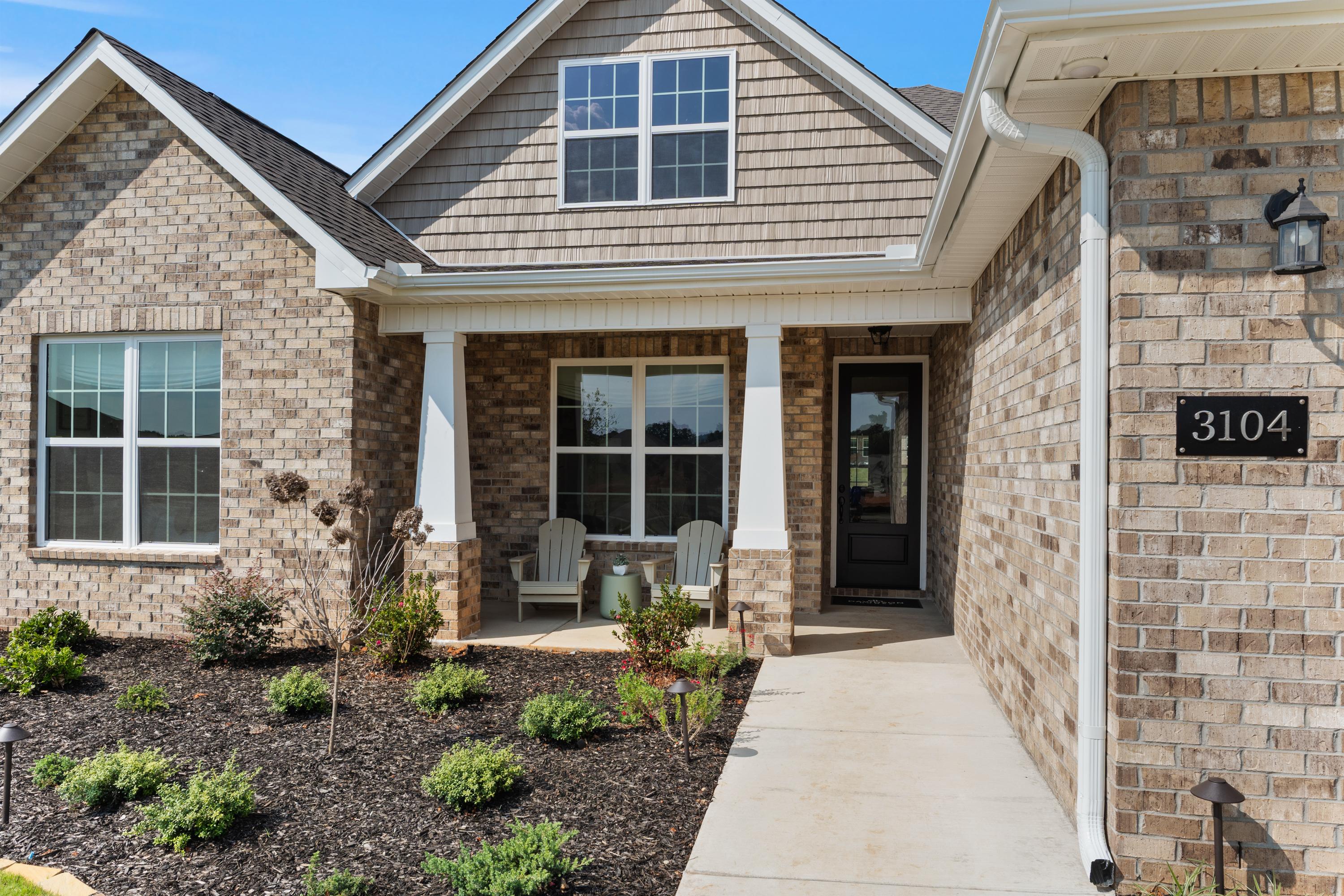 Brick Craftsman home exterior at River Road Estates in Decatur, Alabama with covered porch, columns and landscaping