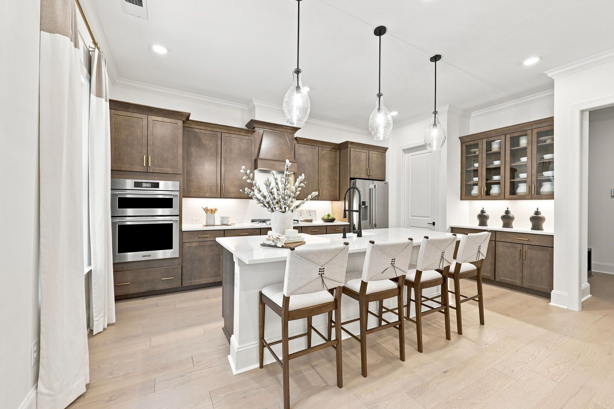 Gourmet kitchen in The Barrington C featuring a large center island, pendant lighting, and custom cabinetry.