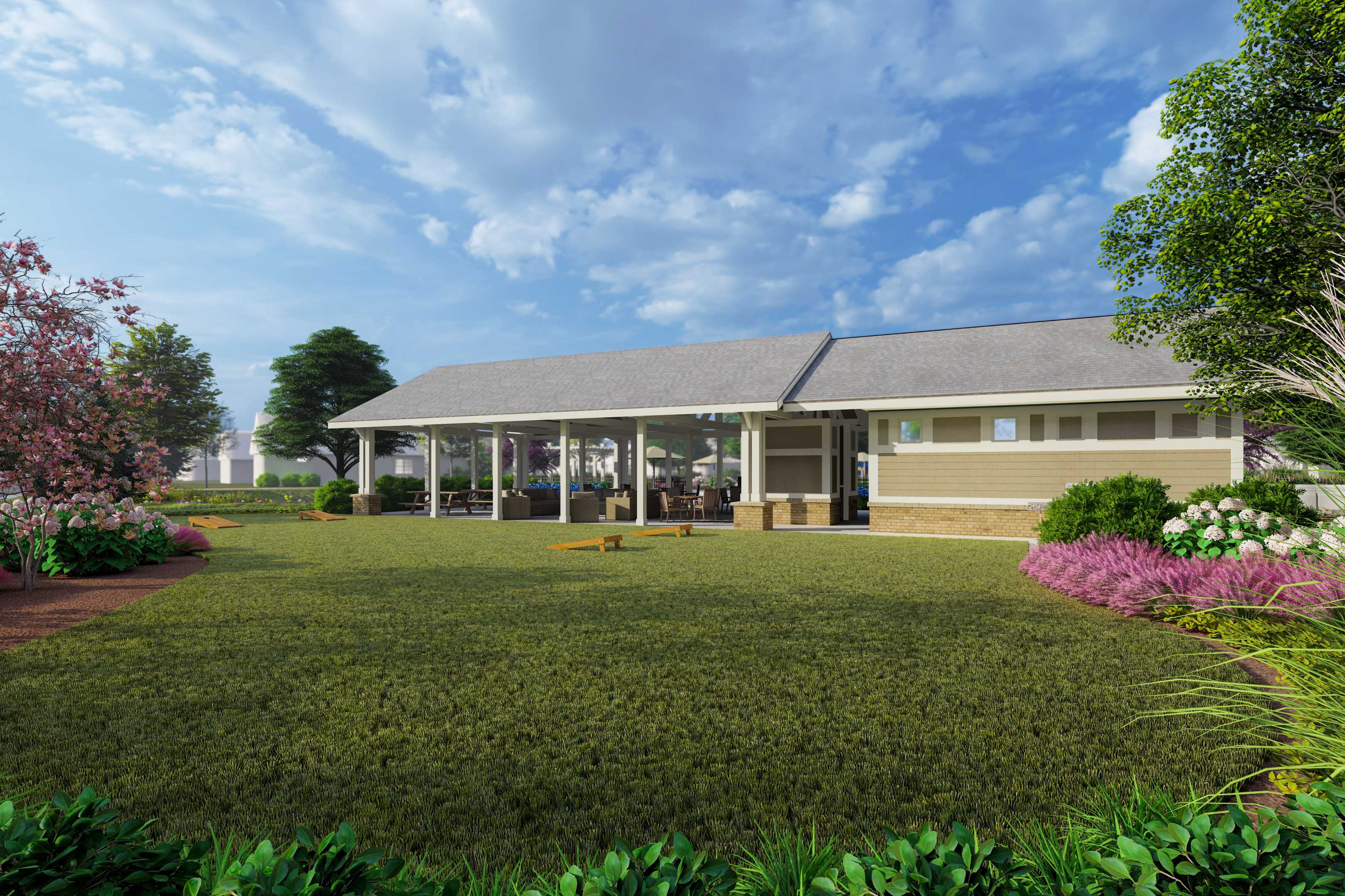 Covered pavilion with white columns at Creekside in Harvest Alabama surrounded by green lawn and pink flowering trees