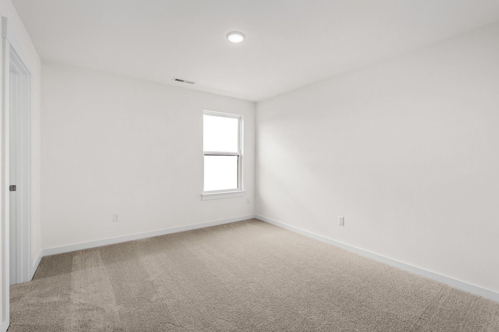 Bright, carpeted bedroom with neutral walls in The Henry C floor plan at Benders Cove, Mt. Juliet, Tennessee.