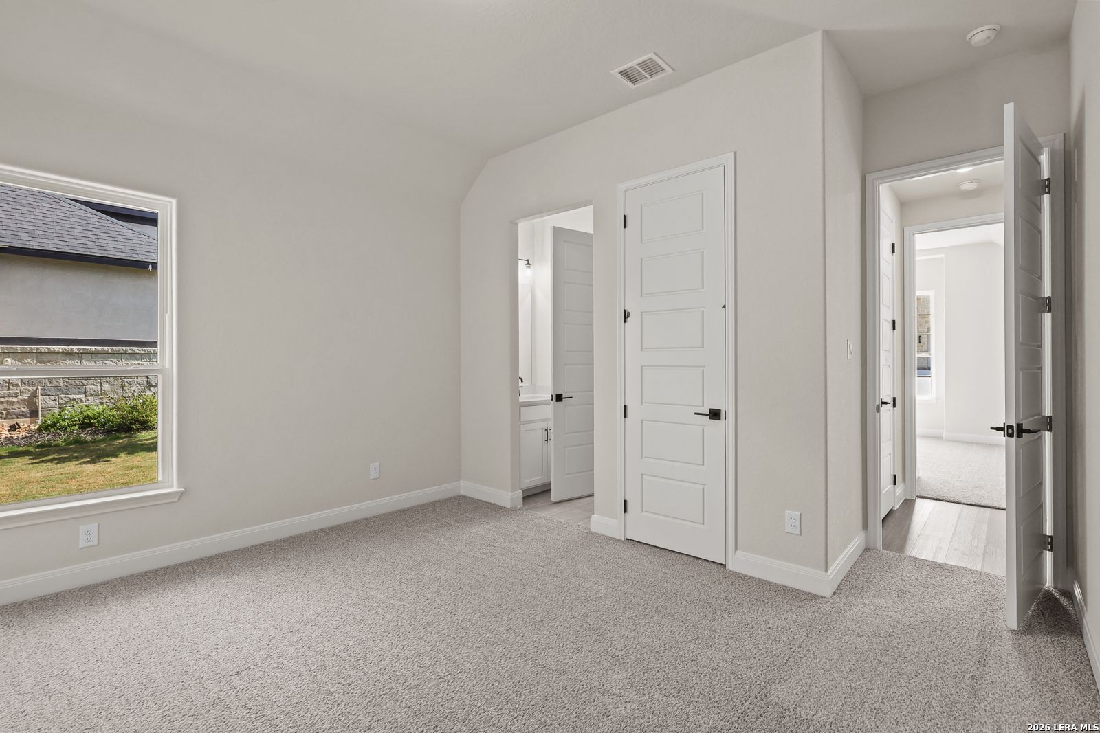 Spacious bedroom with en-suite bathroom in The Summerlin B floor plan by Davidson Homes in Potranco Oaks, Castroville, Texas.