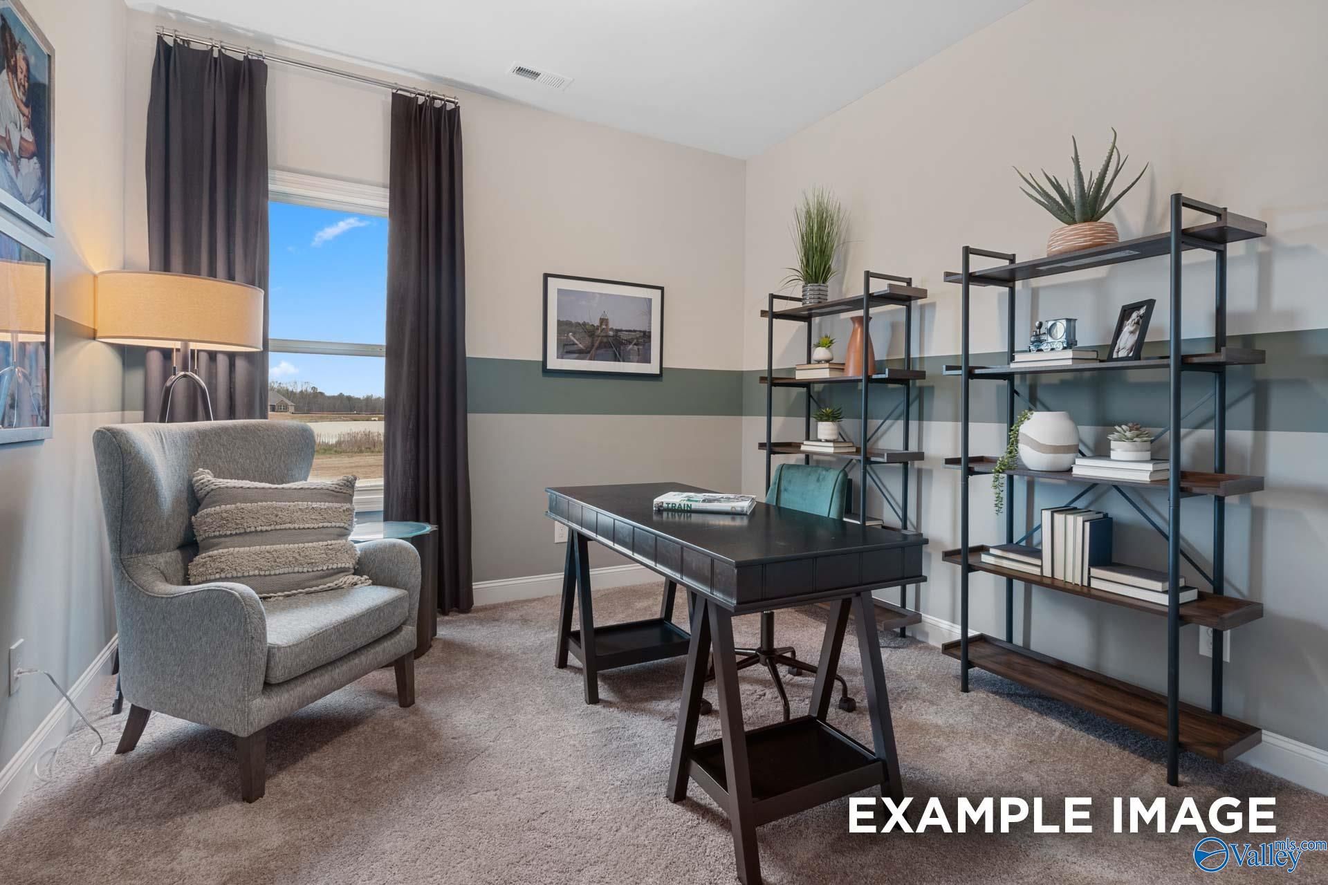 Cozy home office with wingback chair, dark wood desk, and industrial shelving in Davidson Homes Camilla C plan, Hartselle, Alabama