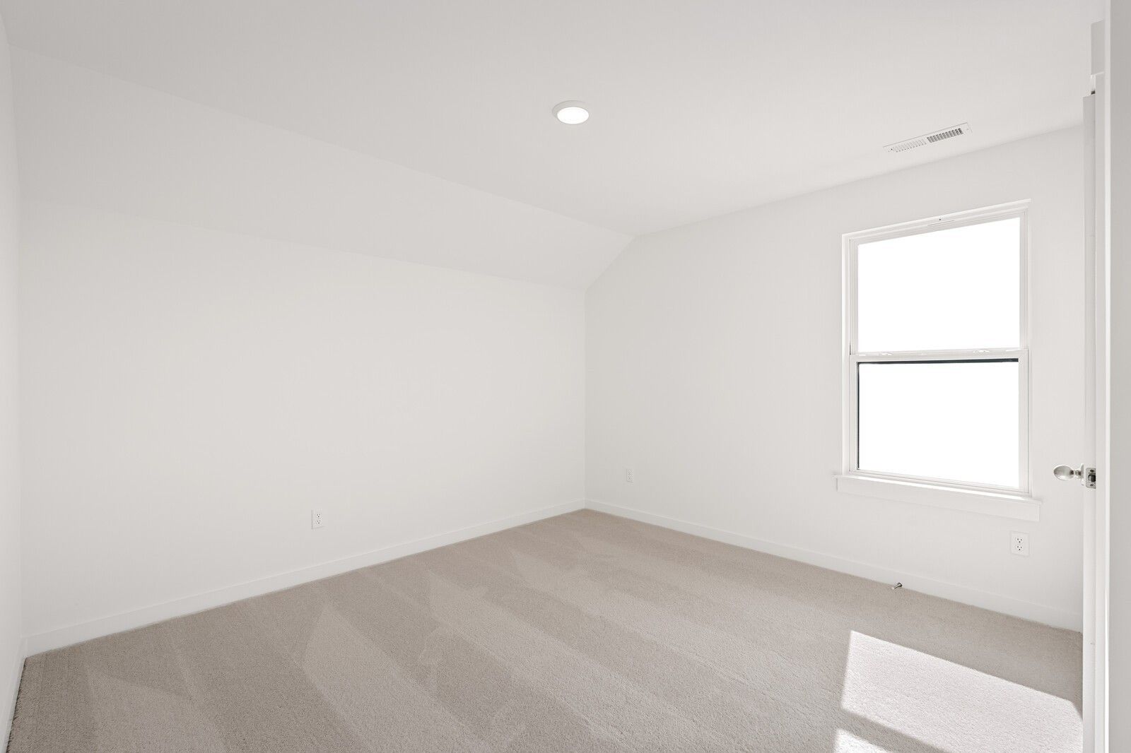 Bright secondary bedroom with sloped ceiling, large window, and light carpet in Davidson Homes The Ash C, Mt. Juliet, TN