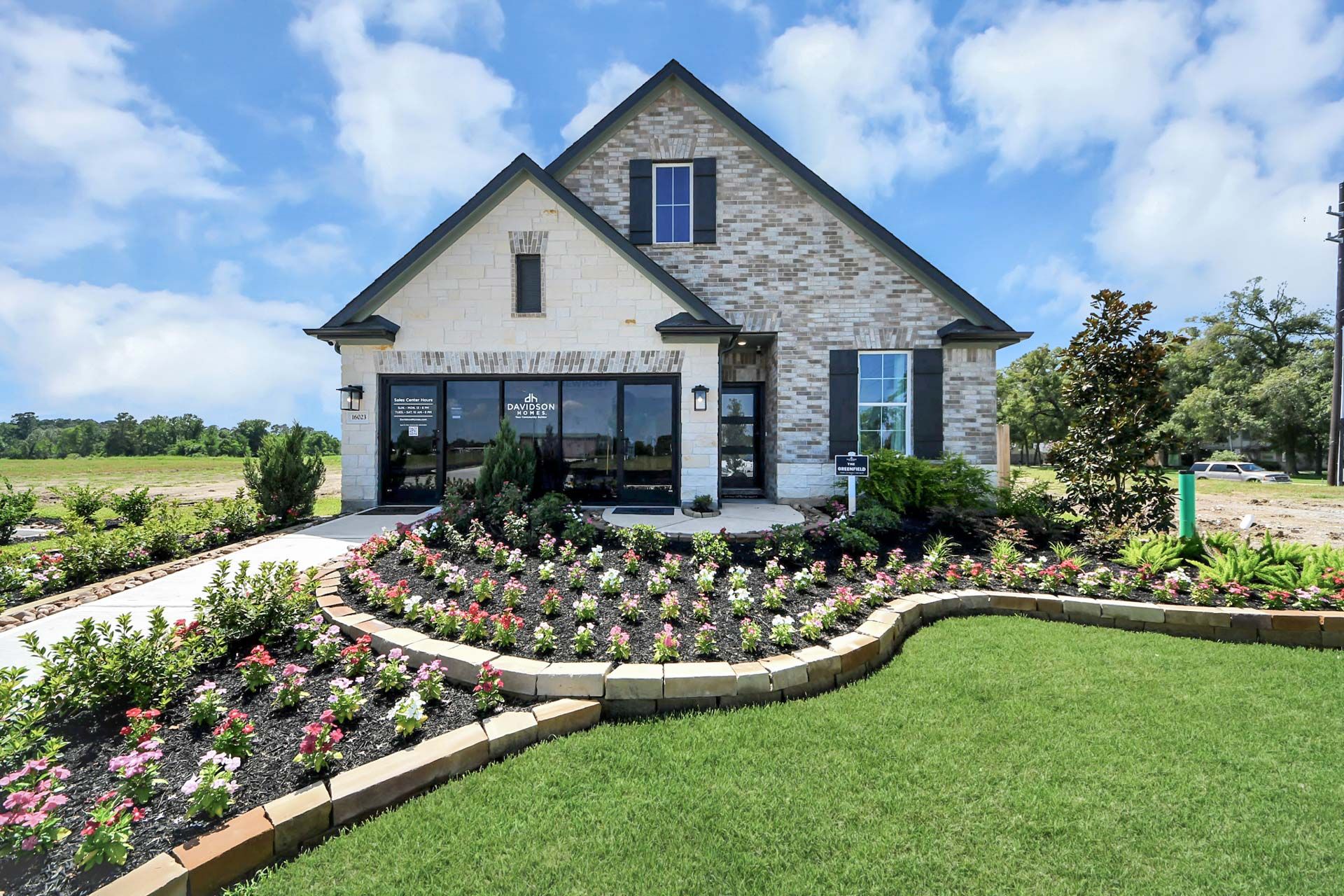 Davidson Homes model exterior at Enclave at Newport in Crosby, Texas, featuring brick facade and landscaped front garden.