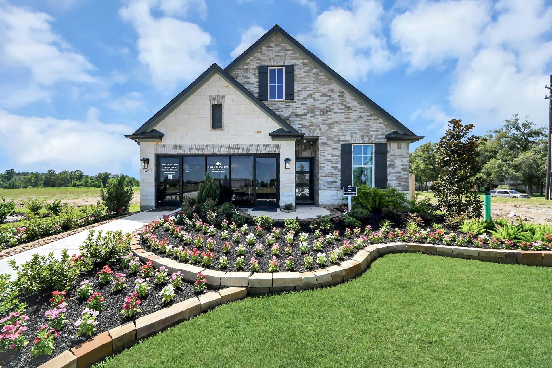 Davidson Homes model exterior at Enclave at Newport in Crosby, Texas, featuring brick facade and landscaped front garden.