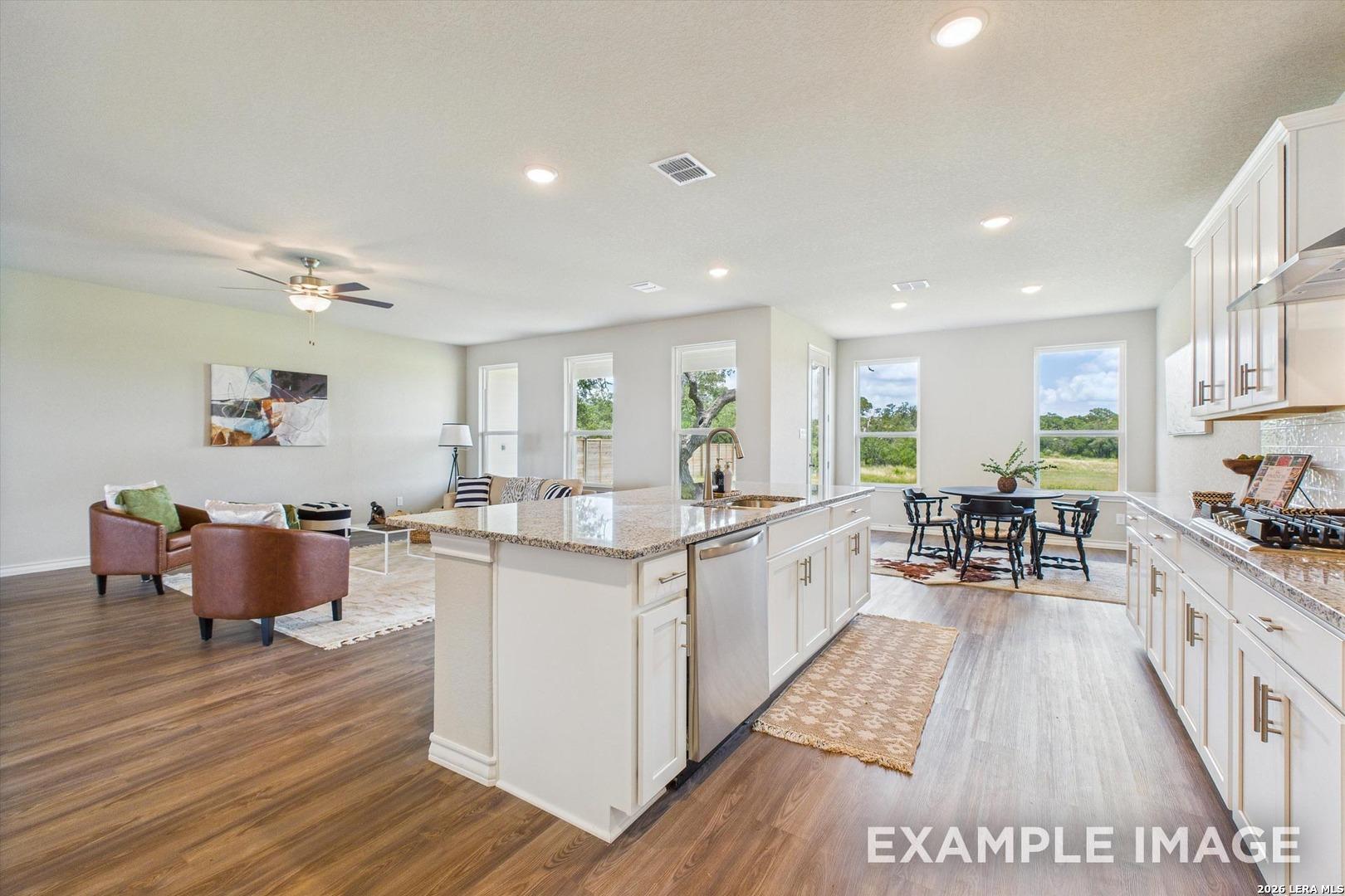 Open-concept kitchen and living area in The Foster F floor plan by Davidson Homes in Potranco Oaks, Castroville, Texas.