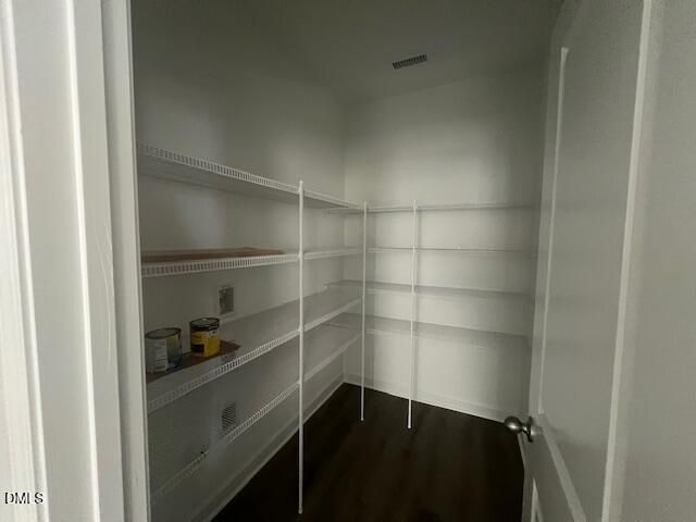 Spacious walk-in pantry with white wire shelving in Davidson Homes The Adalynn A, Gregory Village, Lillington, NC