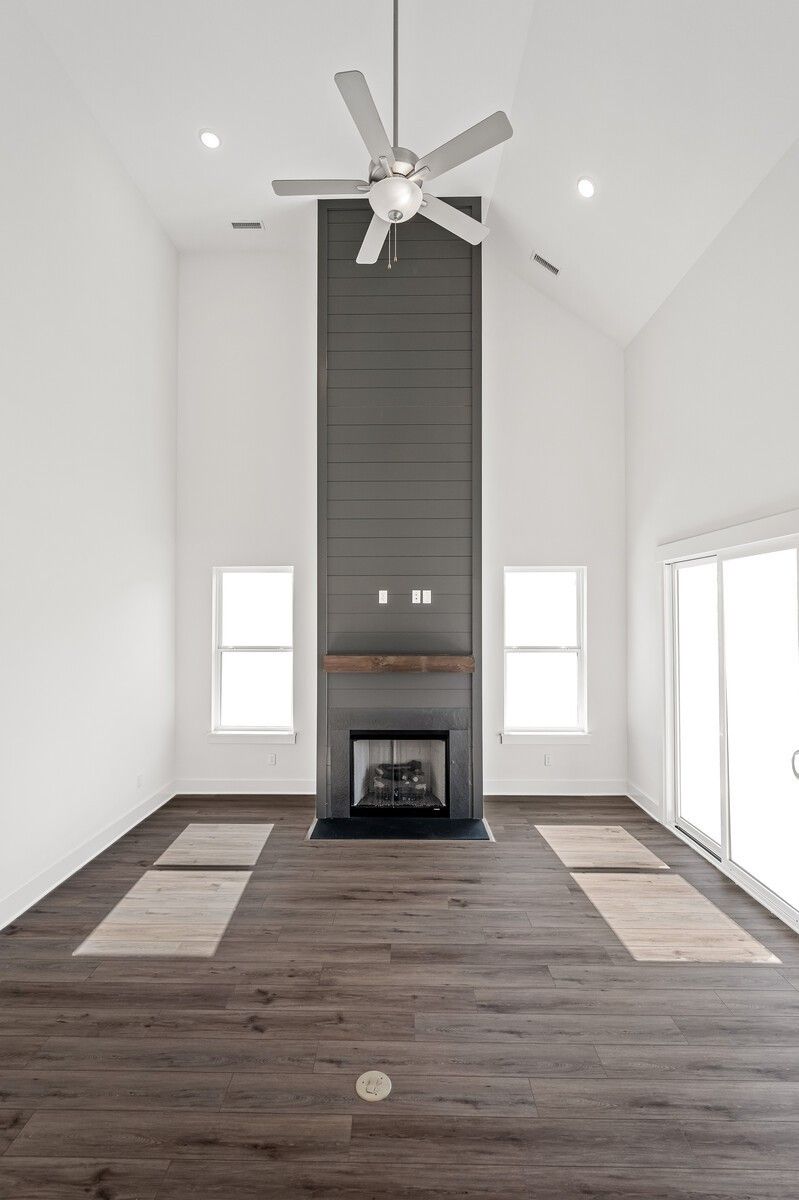 Vaulted two-story great room with stone fireplace, dual ceiling fans, hardwood floors in The Hawkins floor plan, Murfreesboro, TN