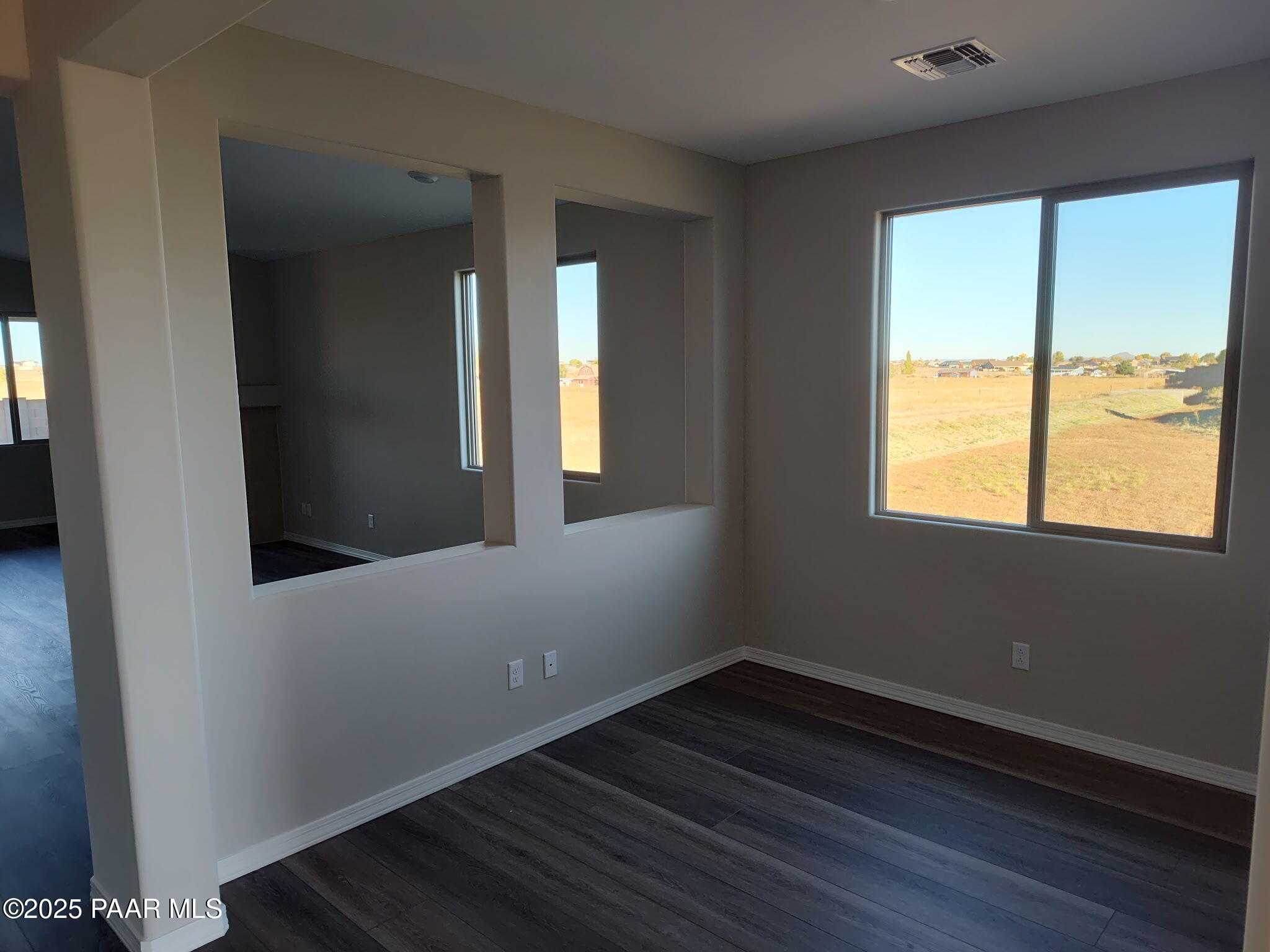 Bright open living room with large windows overlooking Arizona desert in Davidson Homes The Frontier A, Prescott Valley