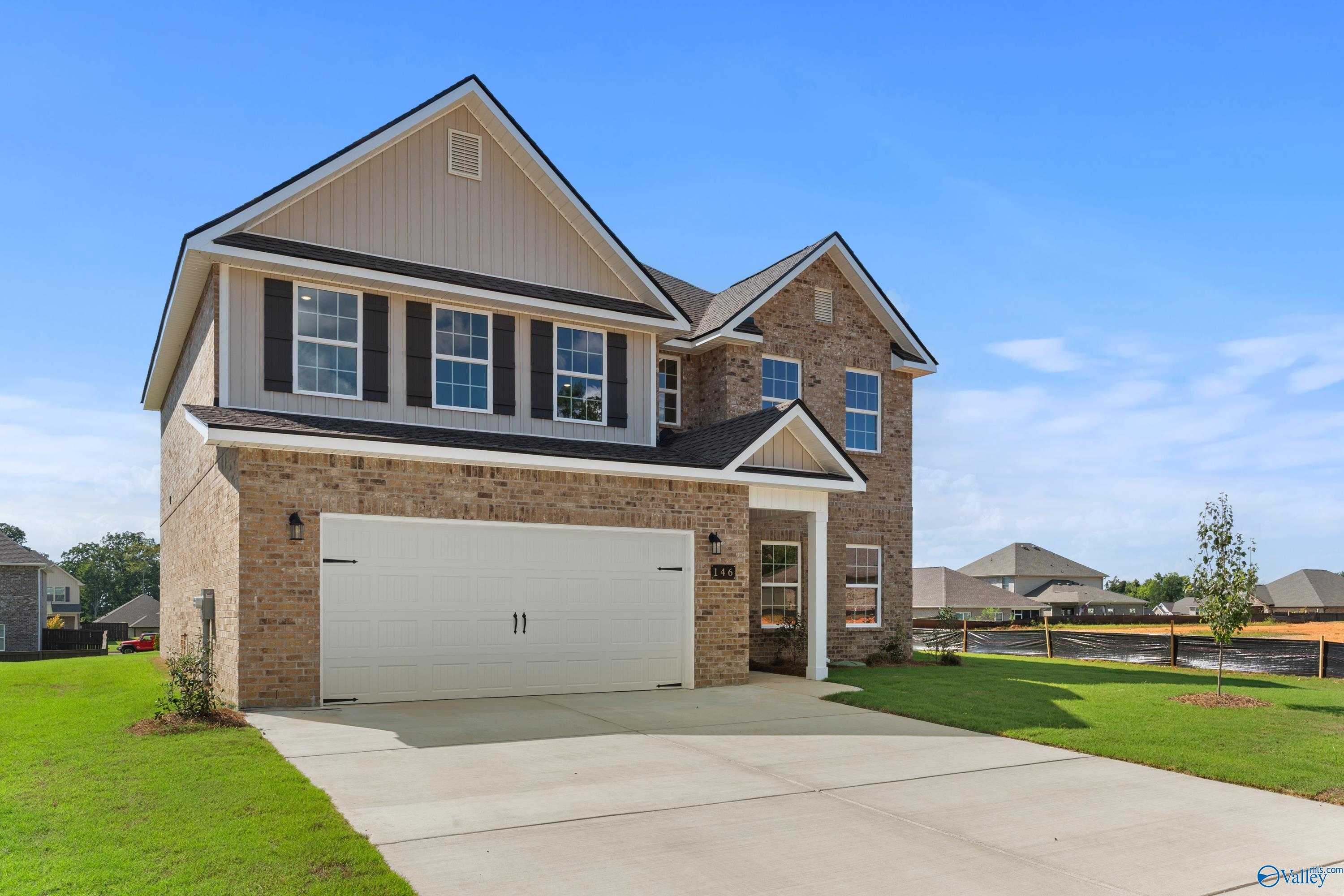 Modern two-story brick home with 2-car garage, driveway, and lush lawn in Creek Grove, New Market, Alabama by Davidson Homes The Shelby A