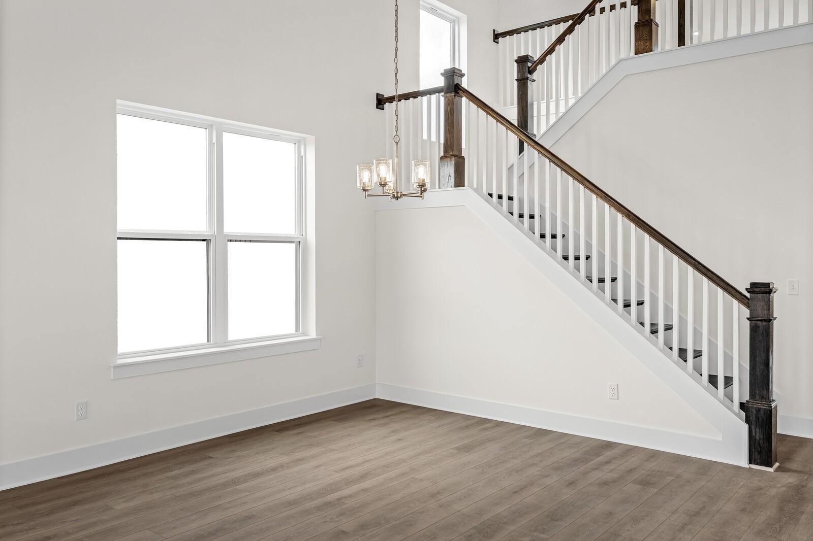 Two-story foyer with staircase and chandelier in The Ridgeport D floor plan by Davidson Homes in Mt. Juliet, Tennessee.