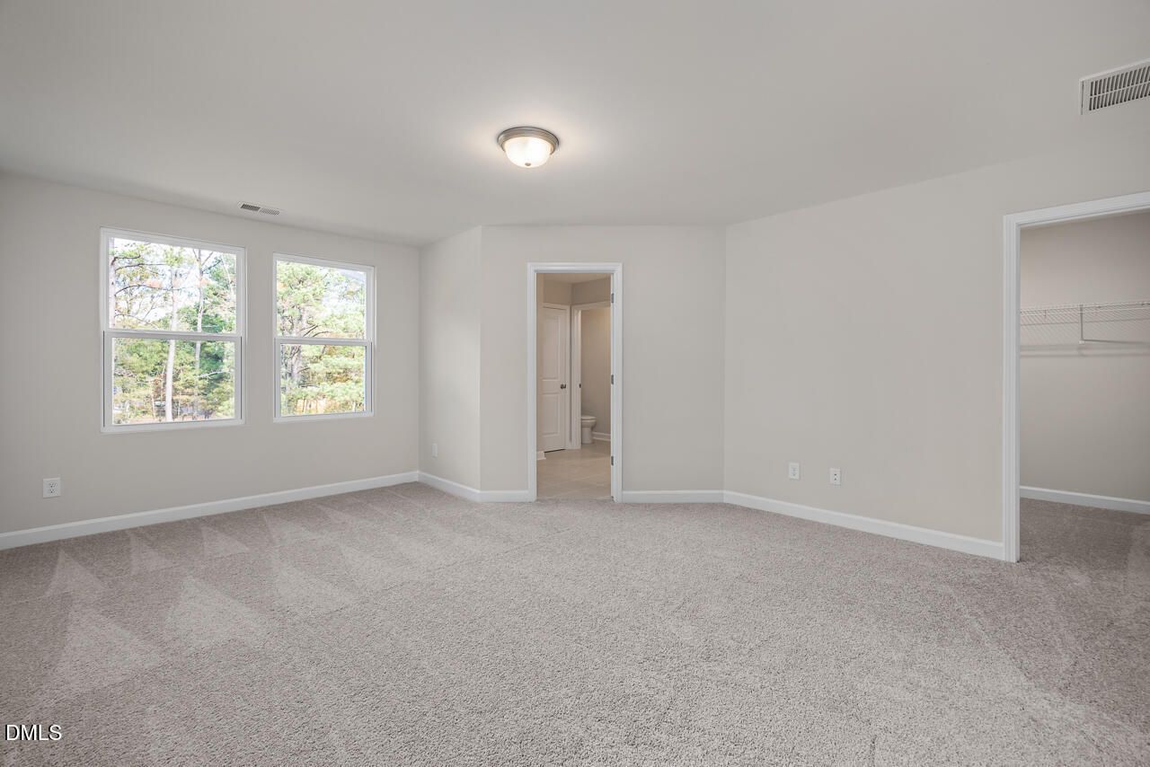 Bright spacious bedroom with en-suite bath and walk-in closet in Davidson Homes The Graham, Springvale, Fuquay-Varina, NC