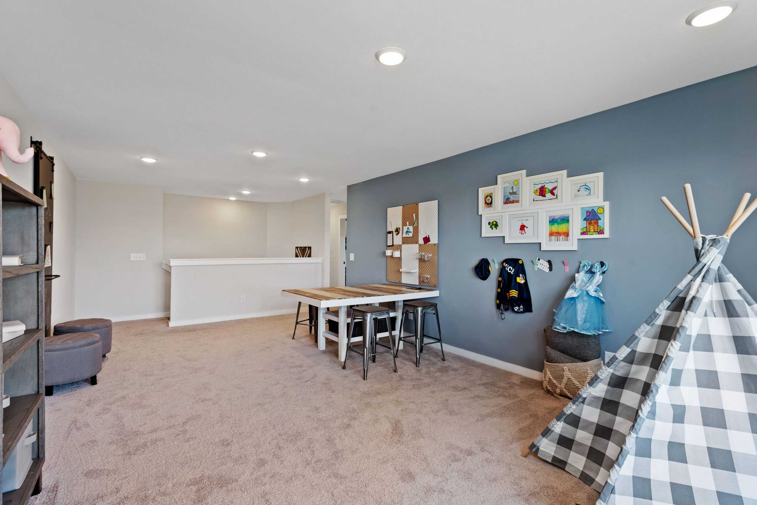 Children's playroom at Rivers Edge in Murfreesboro TN with teepee tent, kids' artwork wall, and wooden table