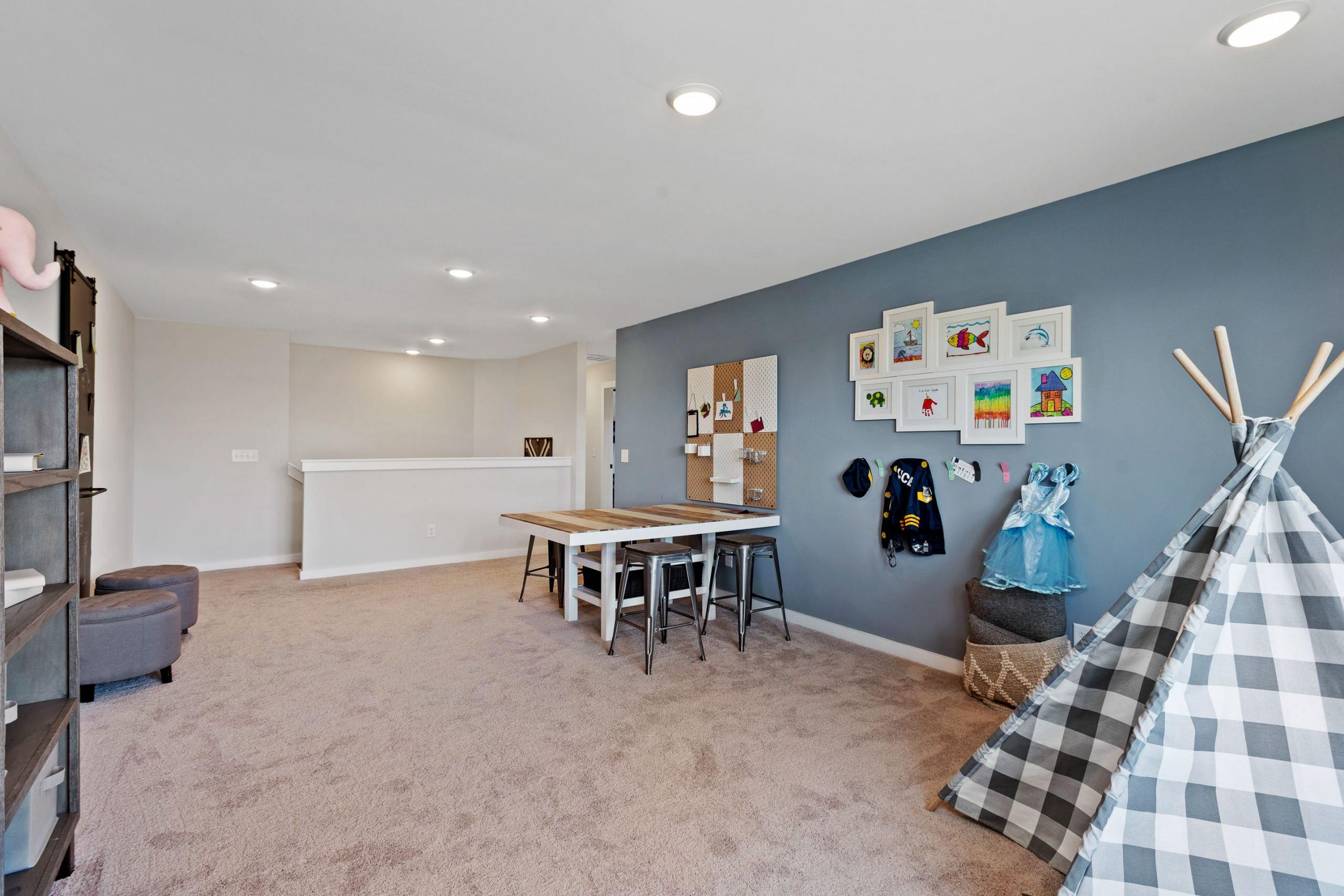 Children's playroom at Rivers Edge in Murfreesboro TN with teepee tent, kids' artwork wall, and wooden table
