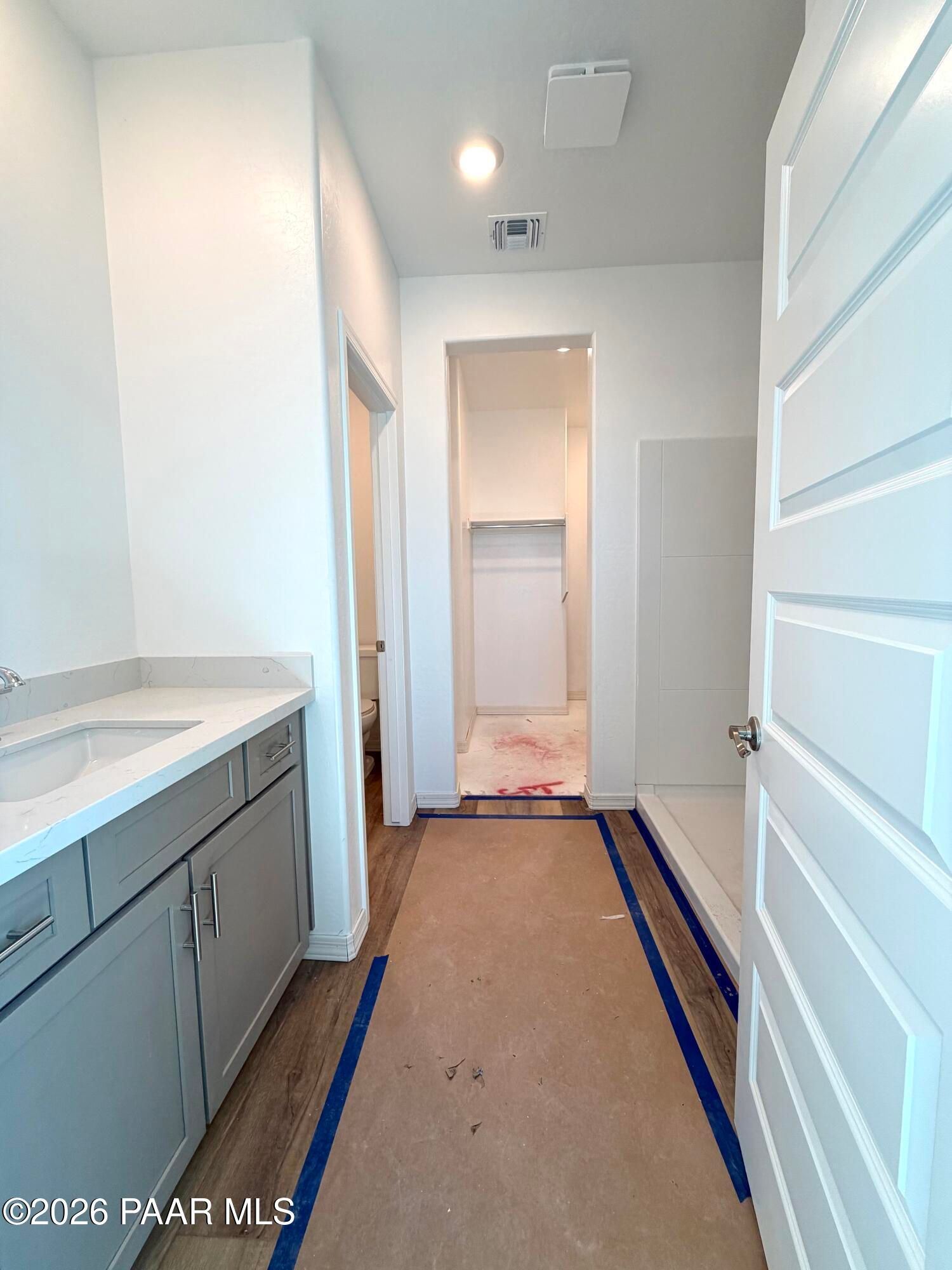 Bathroom with gray vanity, quartz countertop and walk-in shower in Davidson Homes The Marietta C, Prescott, Arizona