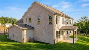 Two-story exterior of The Danbury C floor plan by Davidson Homes featuring a back patio in Melody Lakeside Estates, Buford.