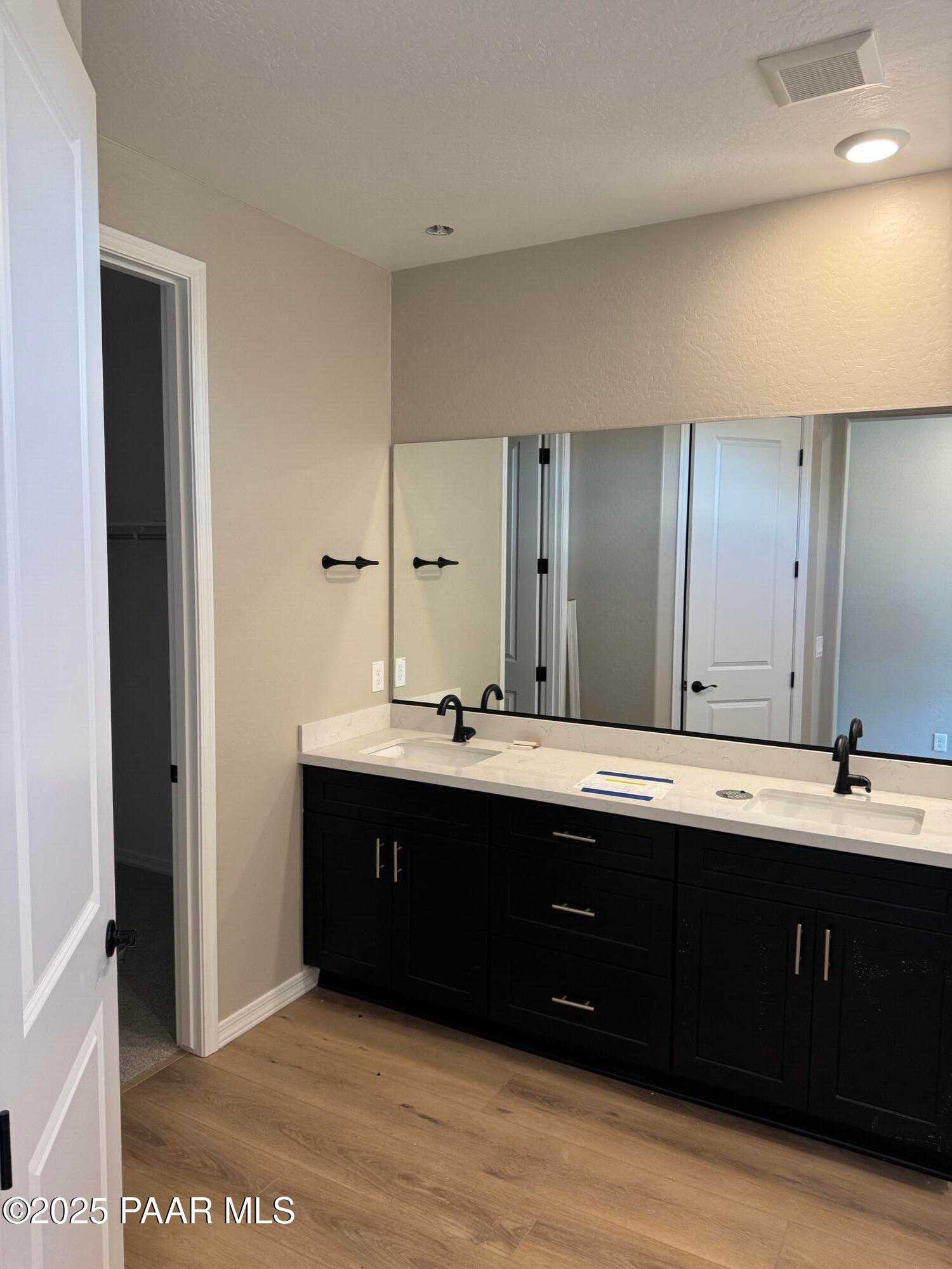 Modern double vanity with black cabinets, white quartz counters, and dual sinks in Davidson Homes The Sheridan II B, Prescott Arizona