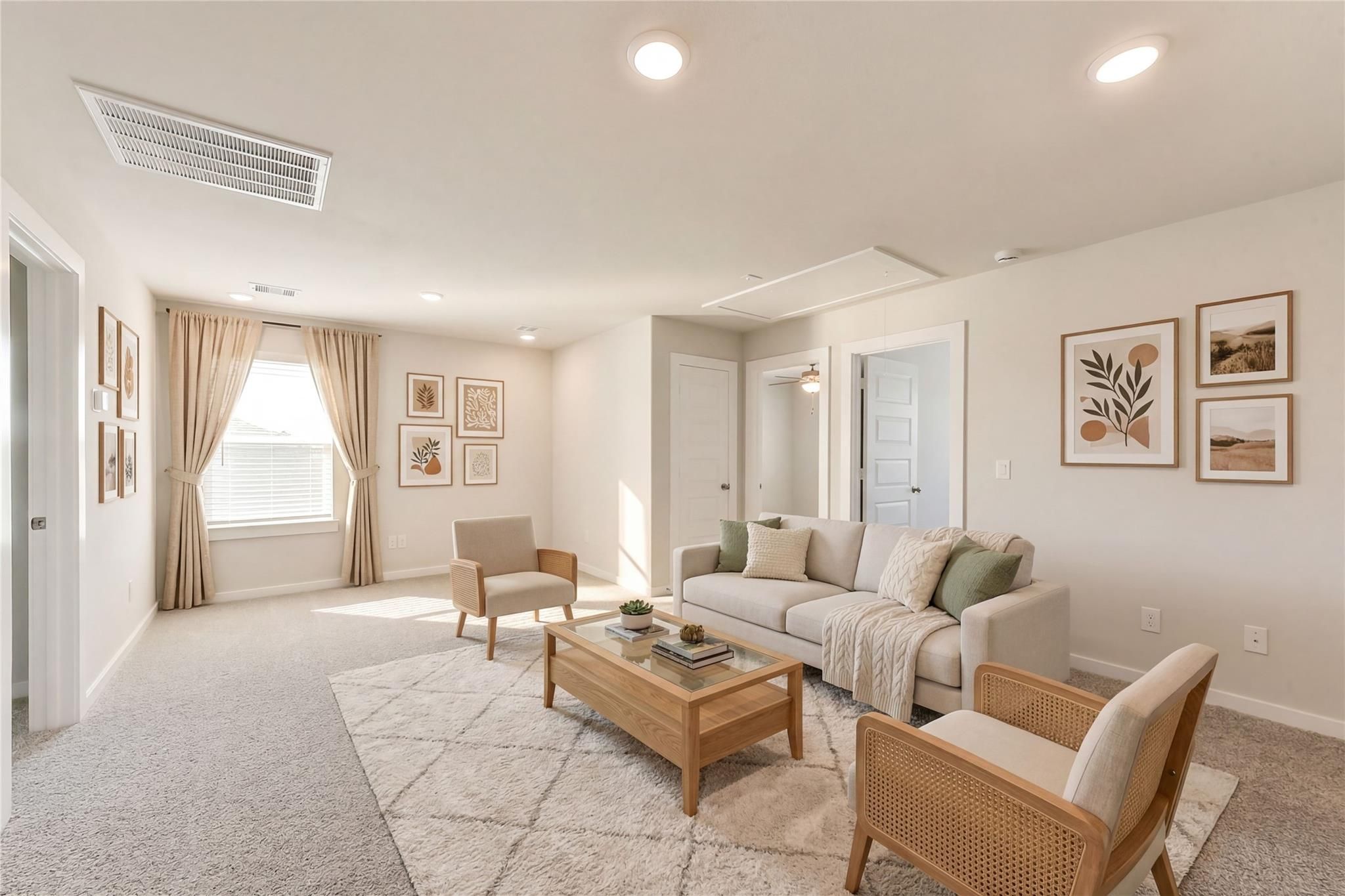 Cozy loft living room with beige sectional sofa, wooden coffee table, armchairs, and abstract art in The Brazos E home, Magnolia, Texas