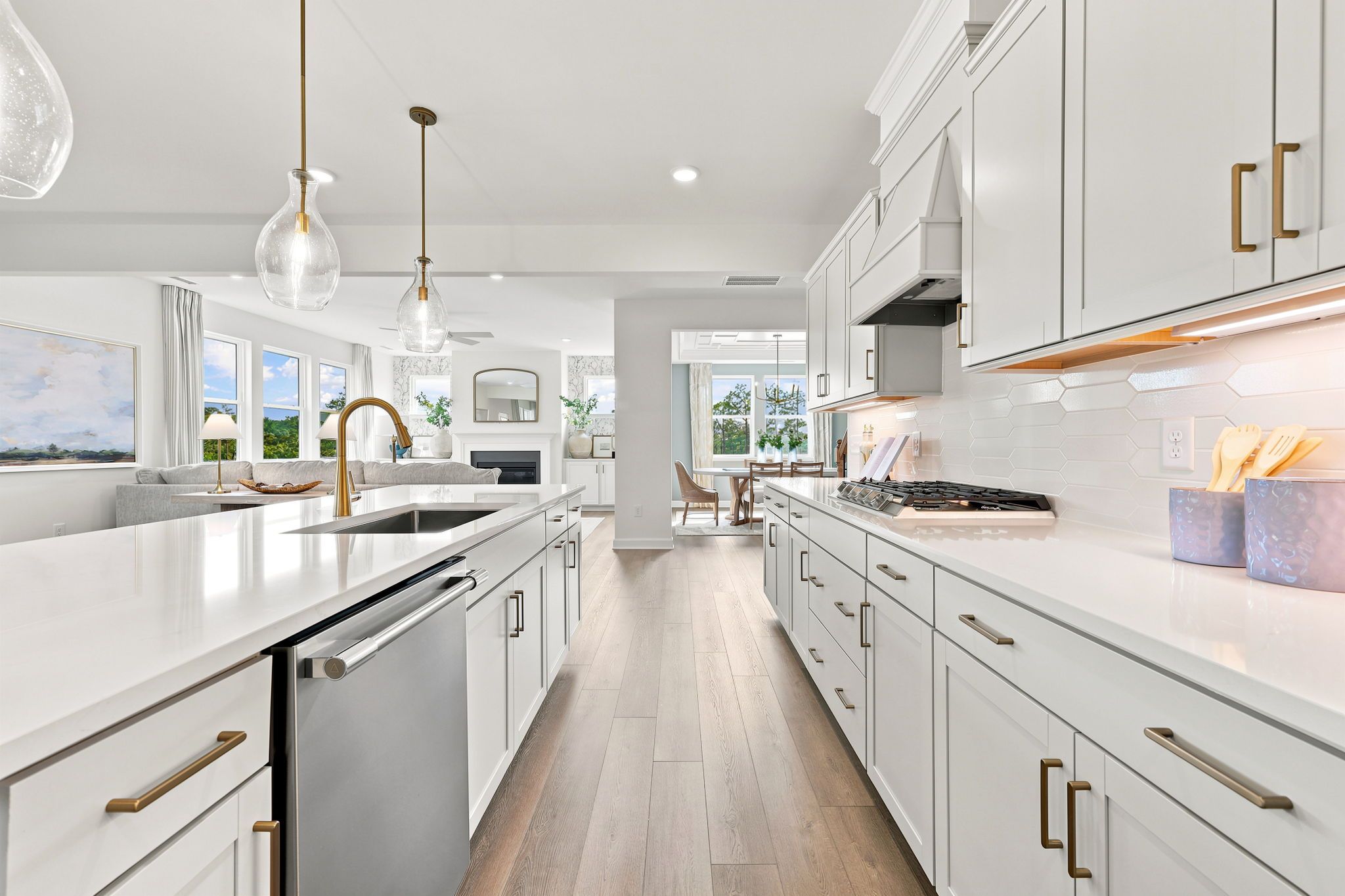 Modern kitchen in The Beech B home featuring white cabinetry, quartz countertops, and an open-concept layout.