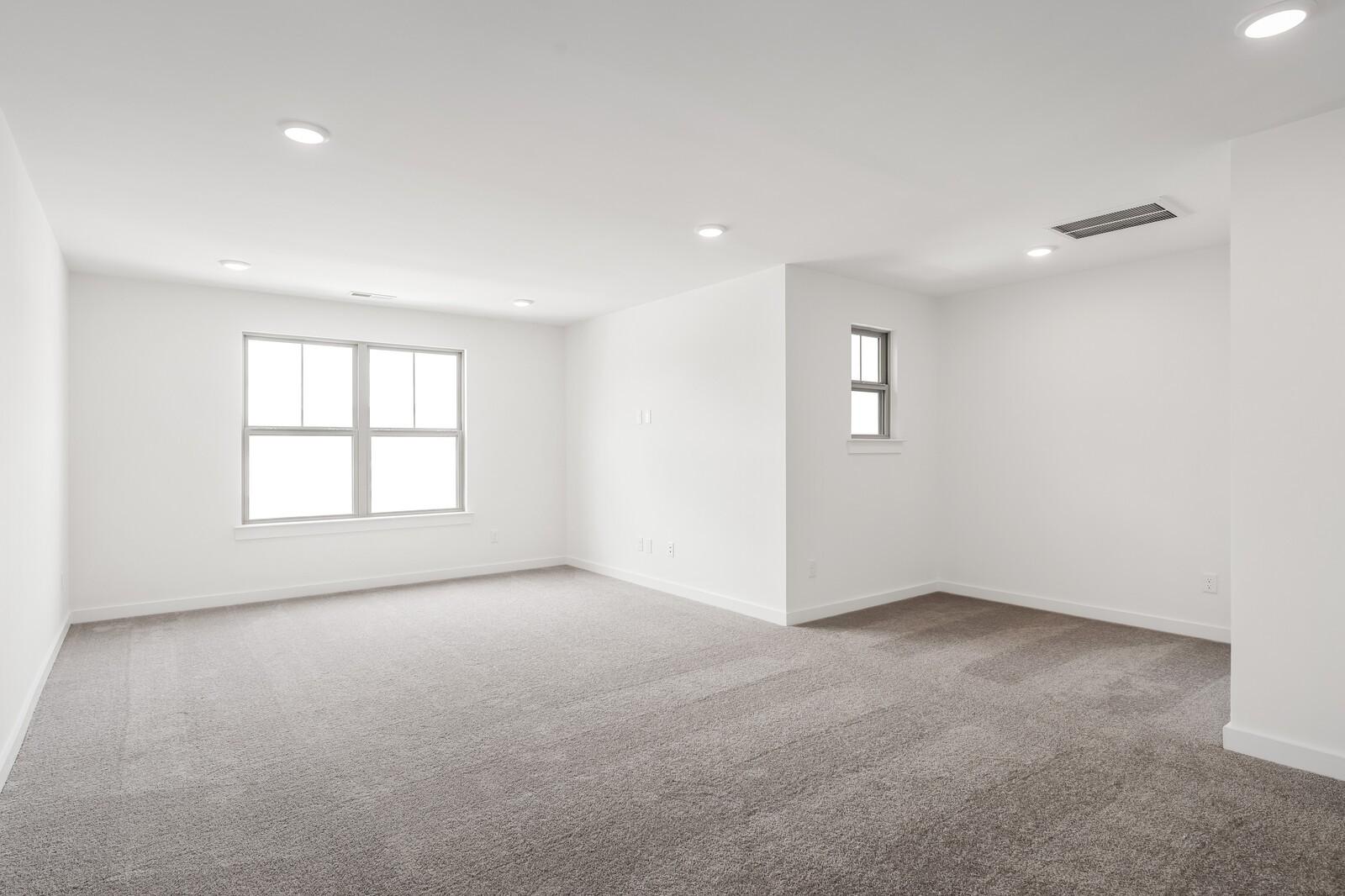 Spacious, light-filled bonus room with plush carpeting in The Ridgeport C floor plan at Woods Crossing, Gallatin, TN.