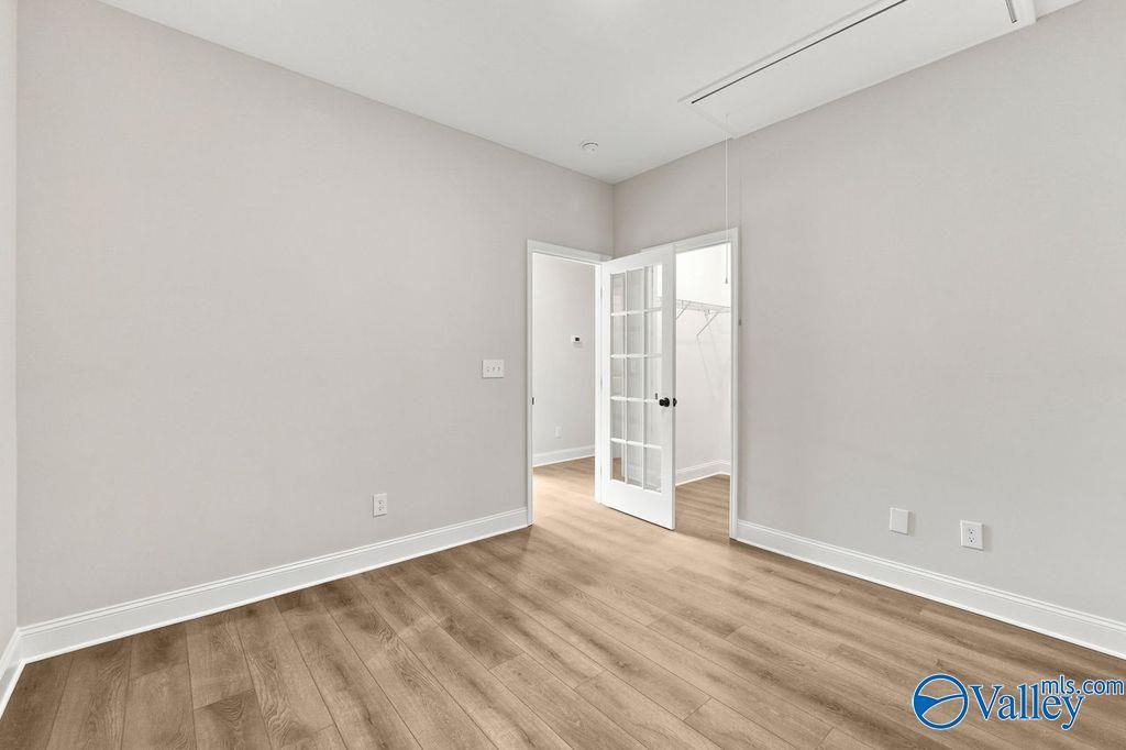Bedroom with French doors leading to walk-in closet in The Camilla C floor plan at The Retreat at Cain Park, Hartselle.