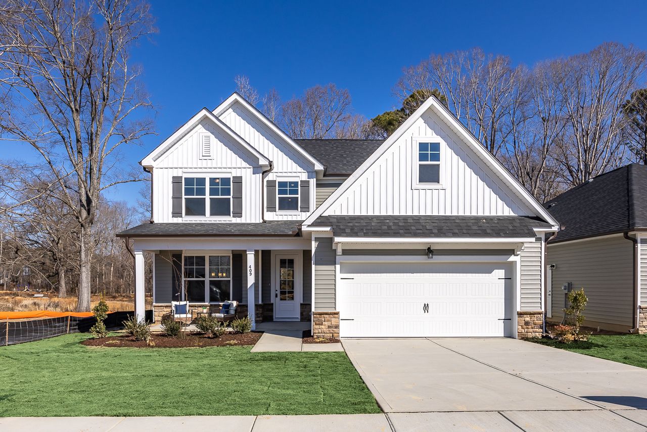 Modern two-story home exterior at Retreat at North Main in Lillington, NC, built by Davidson Homes with a front porch.