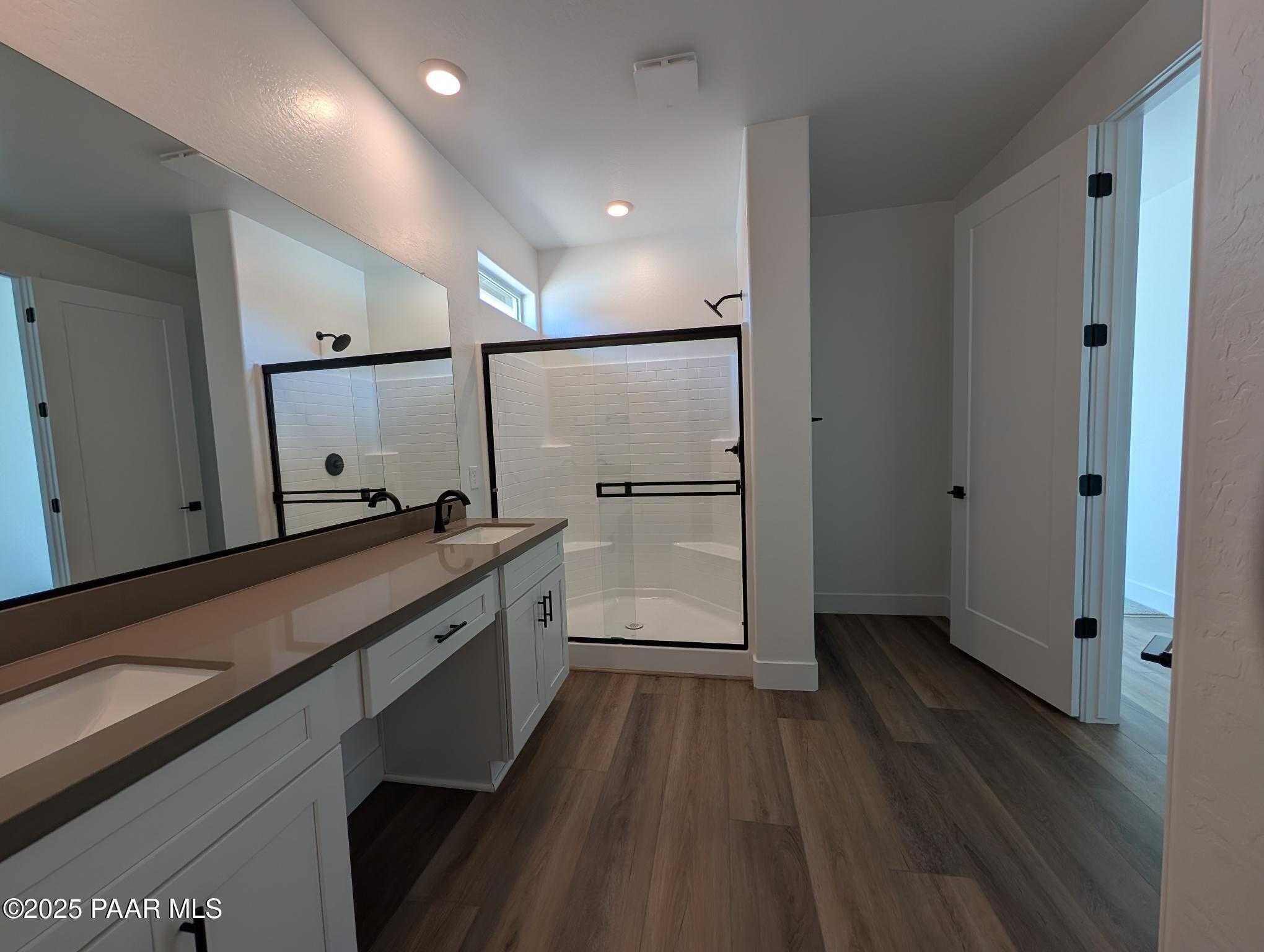Modern master bathroom featuring double quartz vanity, frameless glass shower in Davidson Homes The Sheridan II F, Prescott, Arizona