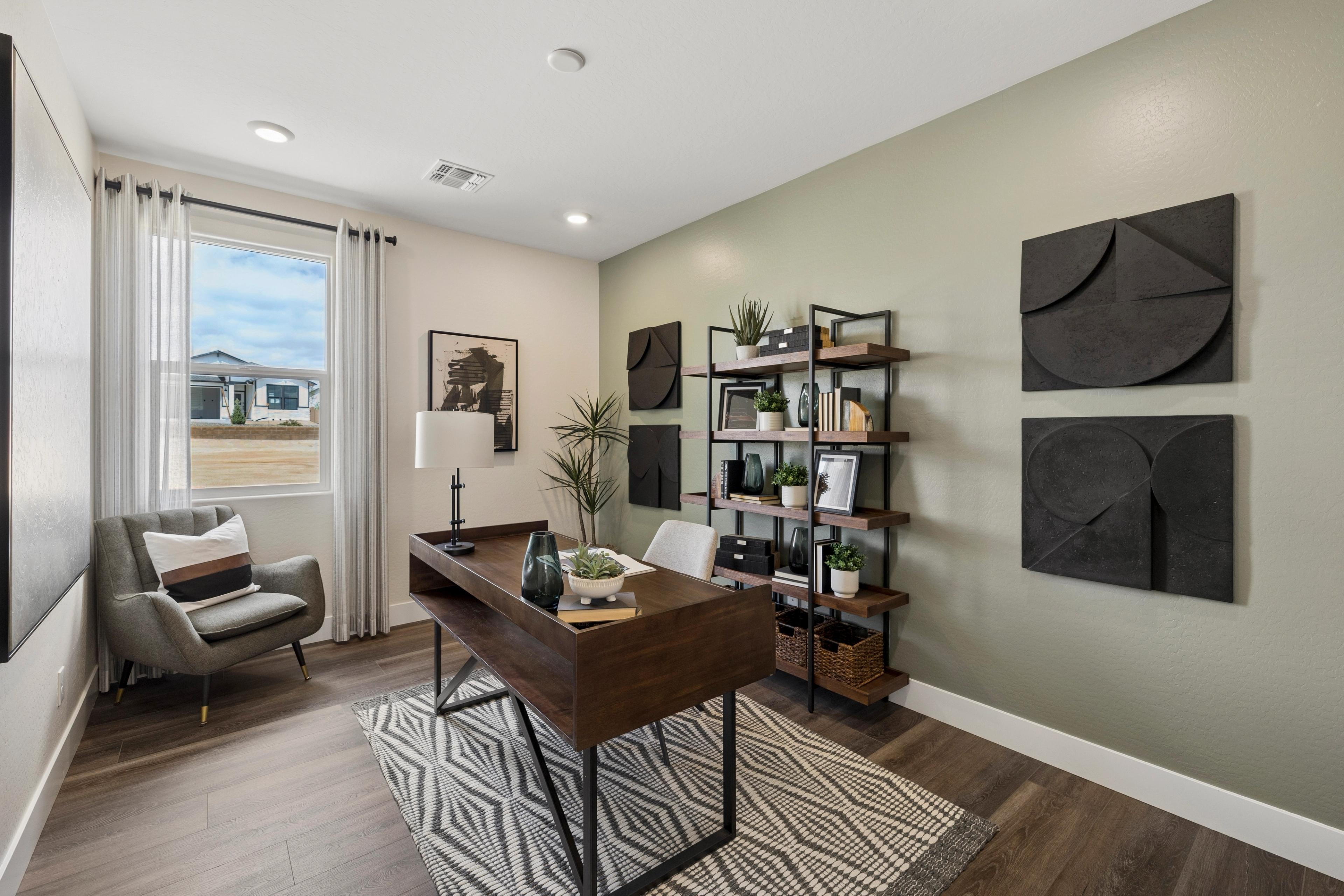 Modern home office in South Ranch Western Collection, Prescott AZ with wooden desk, bookshelf, plants and desert view window