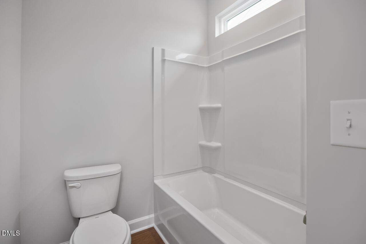 Full bathroom with tub and shower combo in The Ashport L floor plan at Sage on North Main, Wake Forest, North Carolina.