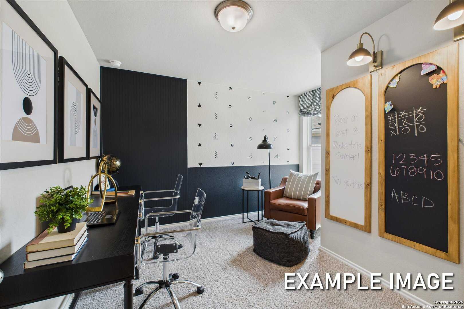 Modern home office with black accent wall, chalkboard panels, desk, armchair, and abstract art in Davidson Homes Sabine C, San Antonio