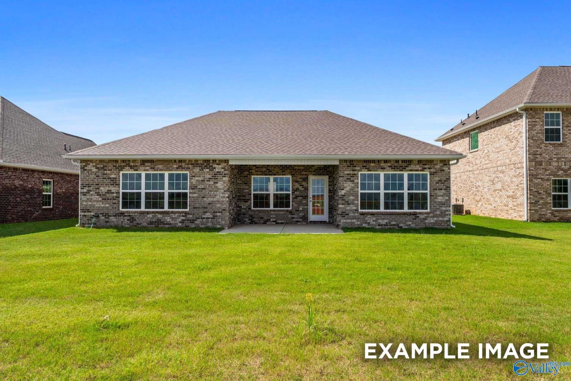 Single-story brick home with gabled roof and large windows, The Montgomery plan by Davidson Homes in The Meadows, Athens, Alabama