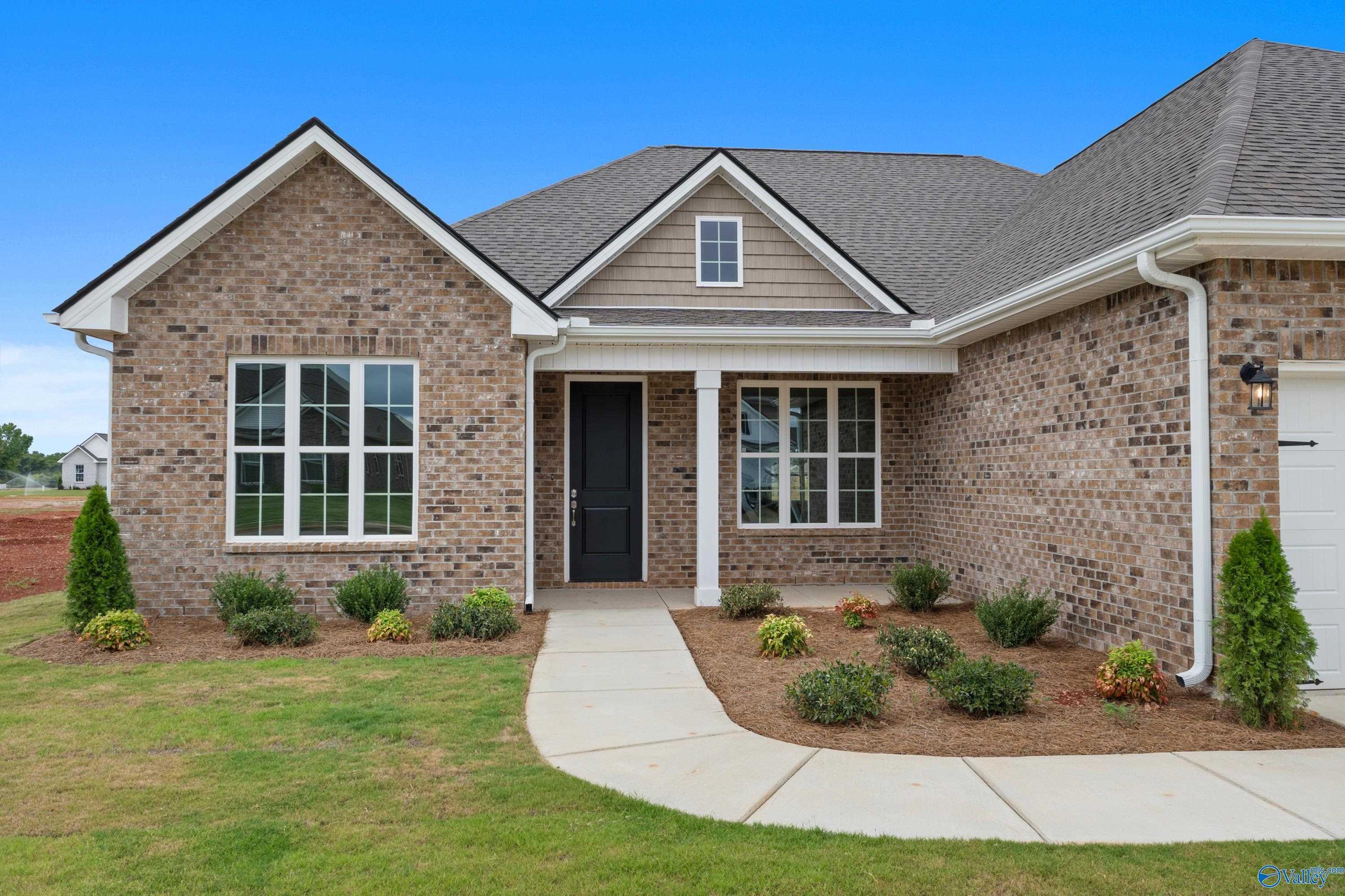 Single-story brick home with gabled roof, 2-car garage, and landscaped entry in Briercreek, Meridianville, Alabama