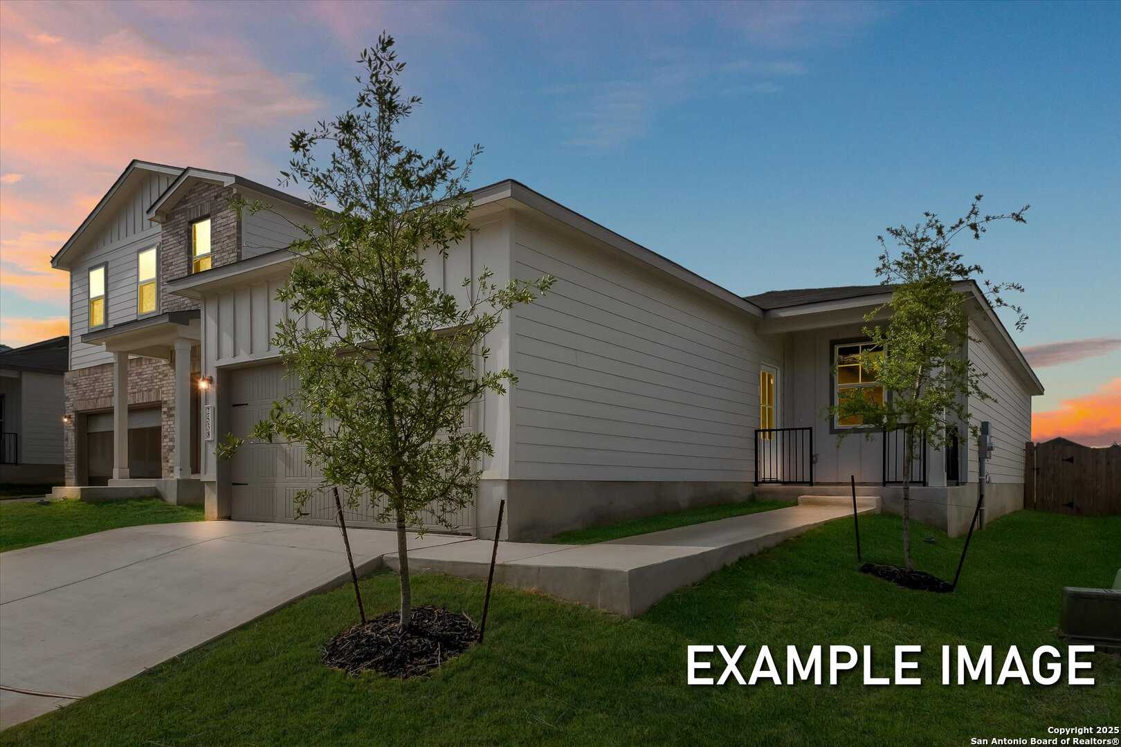 Modern 1-story Comal B home exterior with 2-car garage, stone accents, and landscaped yard in Agave, San Antonio, Texas