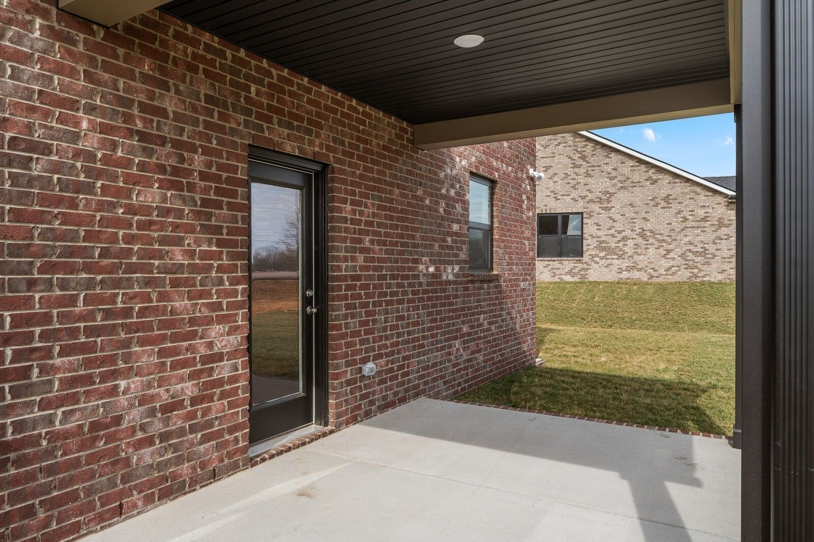 Covered brick patio with rear door access in The Henry C floor plan at Benders Cove, Mt. Juliet, Tennessee.