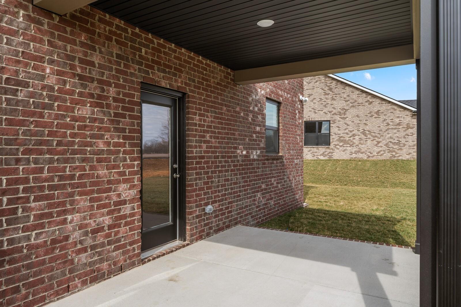 Covered brick patio with rear door access in The Henry C floor plan at Benders Cove, Mt. Juliet, Tennessee.