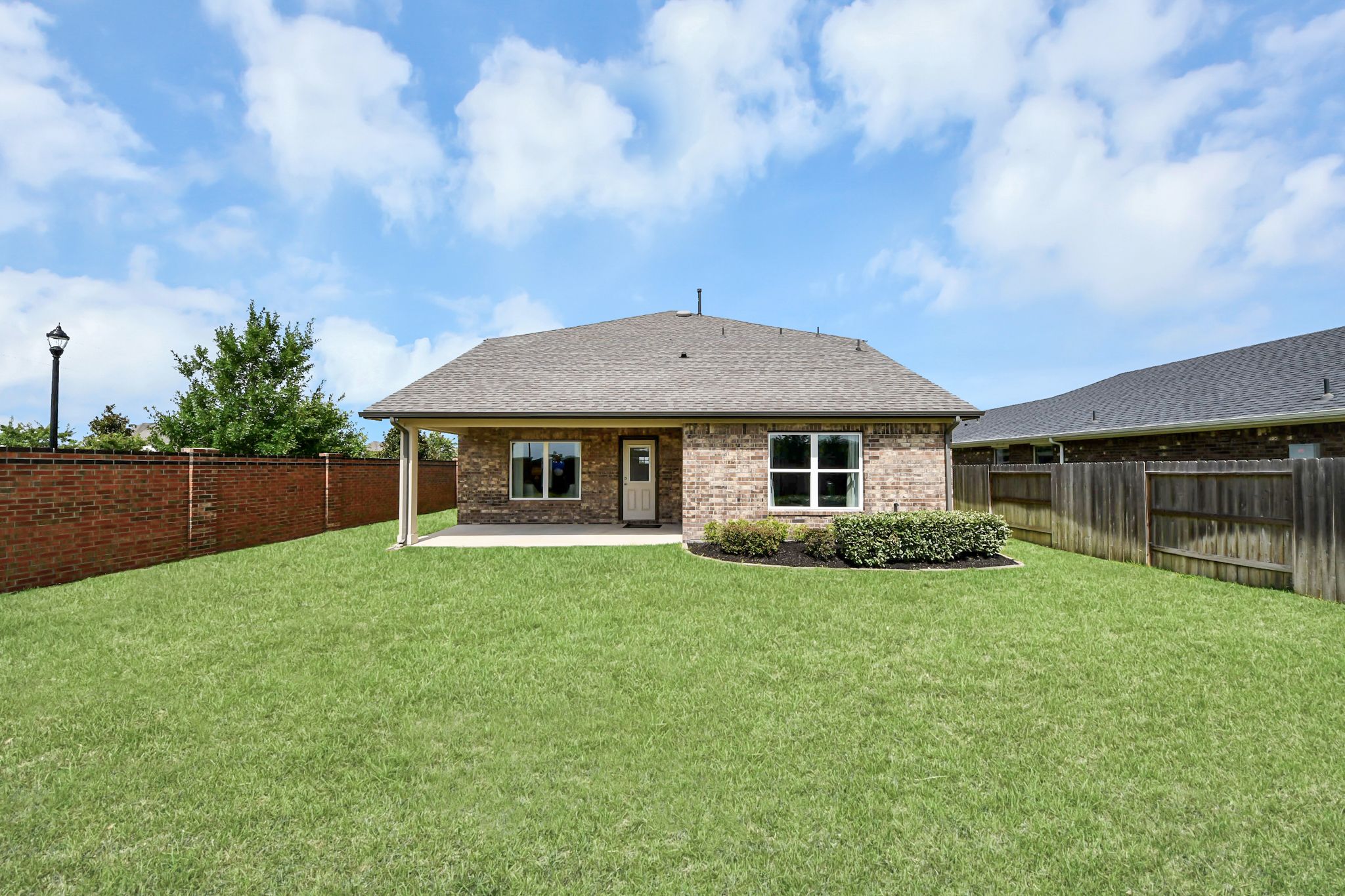Spacious backyard with covered patio at a Davidson Homes property in Sunterra, Katy, Texas.